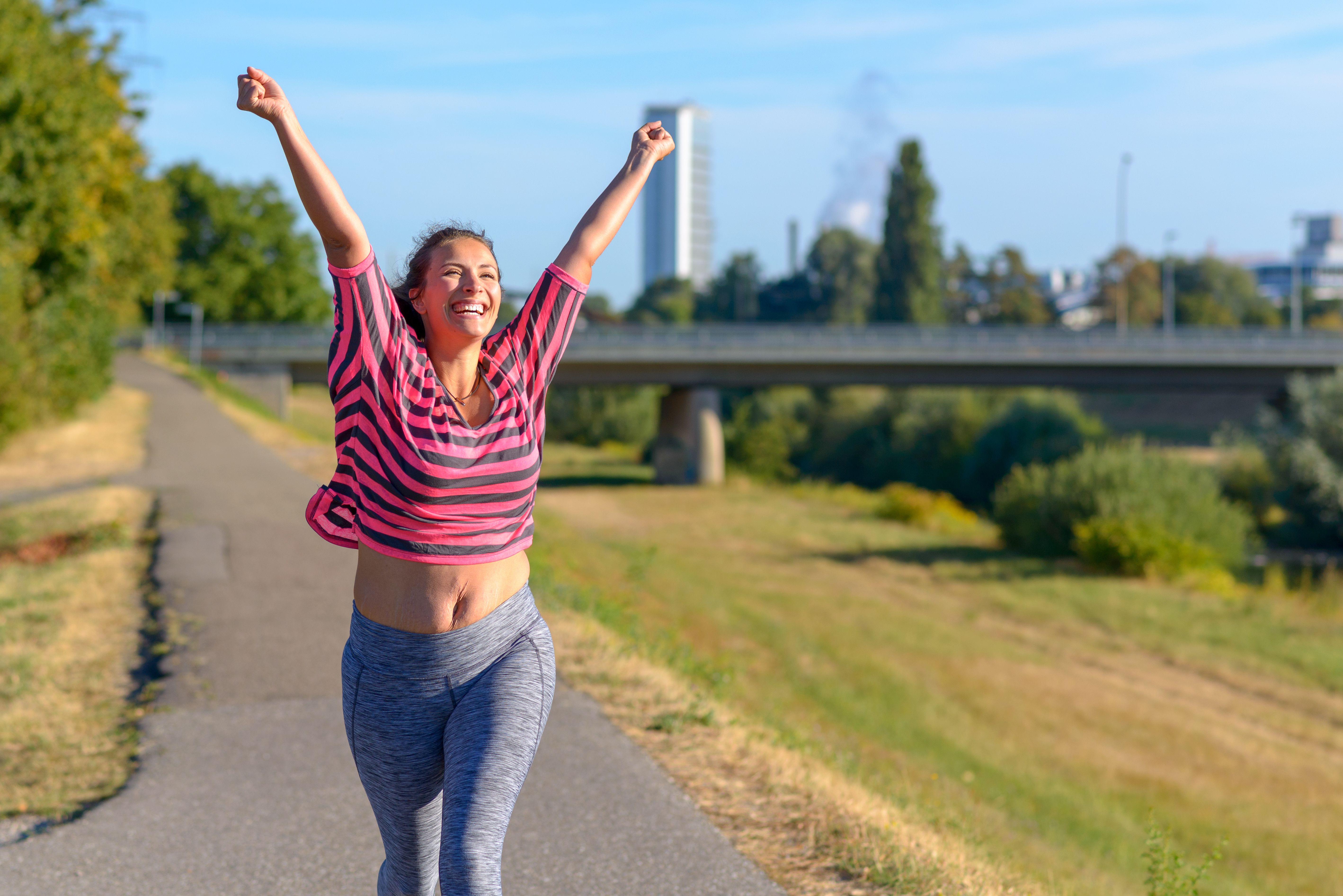 Happy fit woman cheering and celebrating