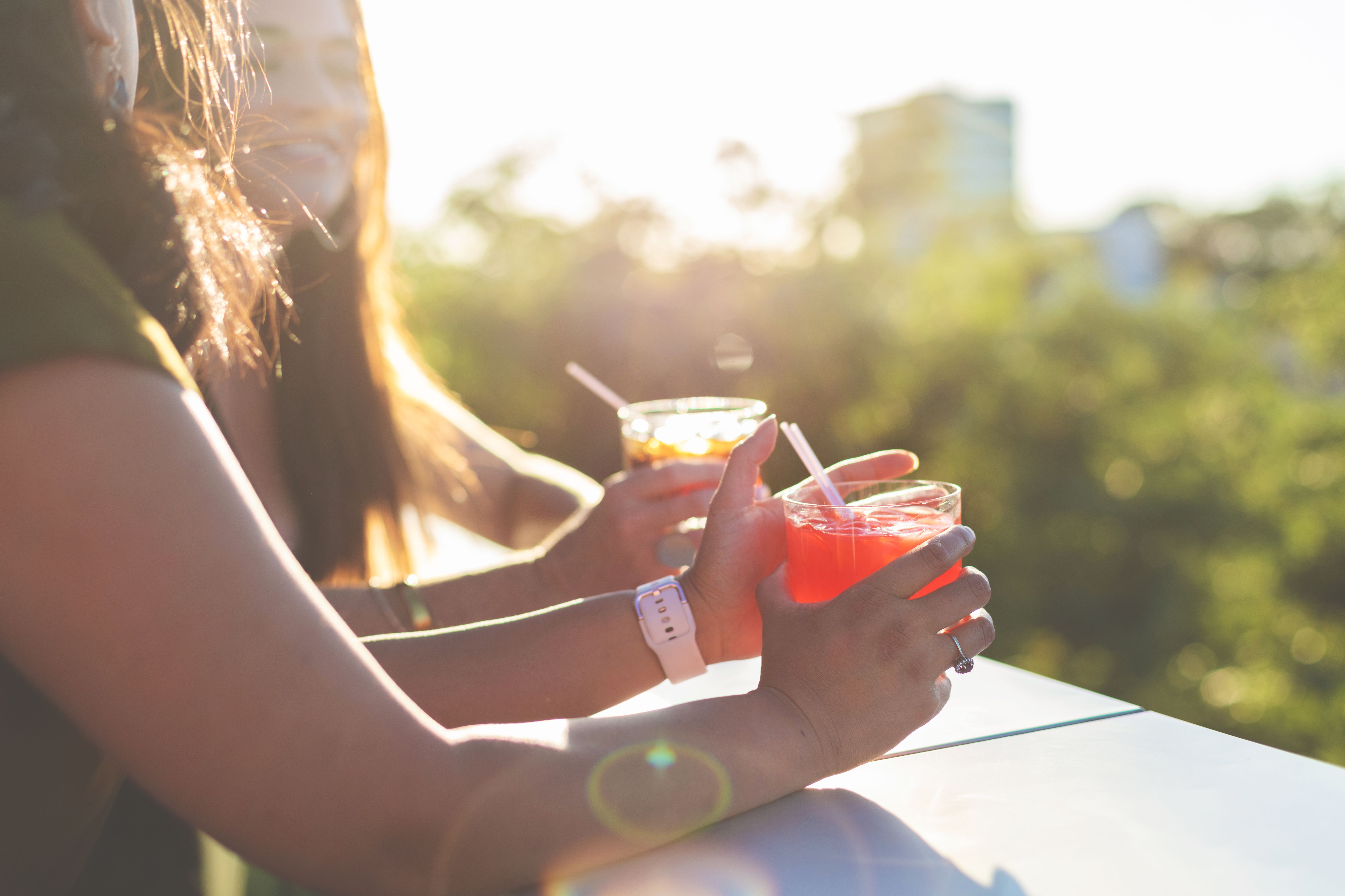 Attractive Vibrant Females At Sunset Enjoying and An Urban Environment with Cocktails