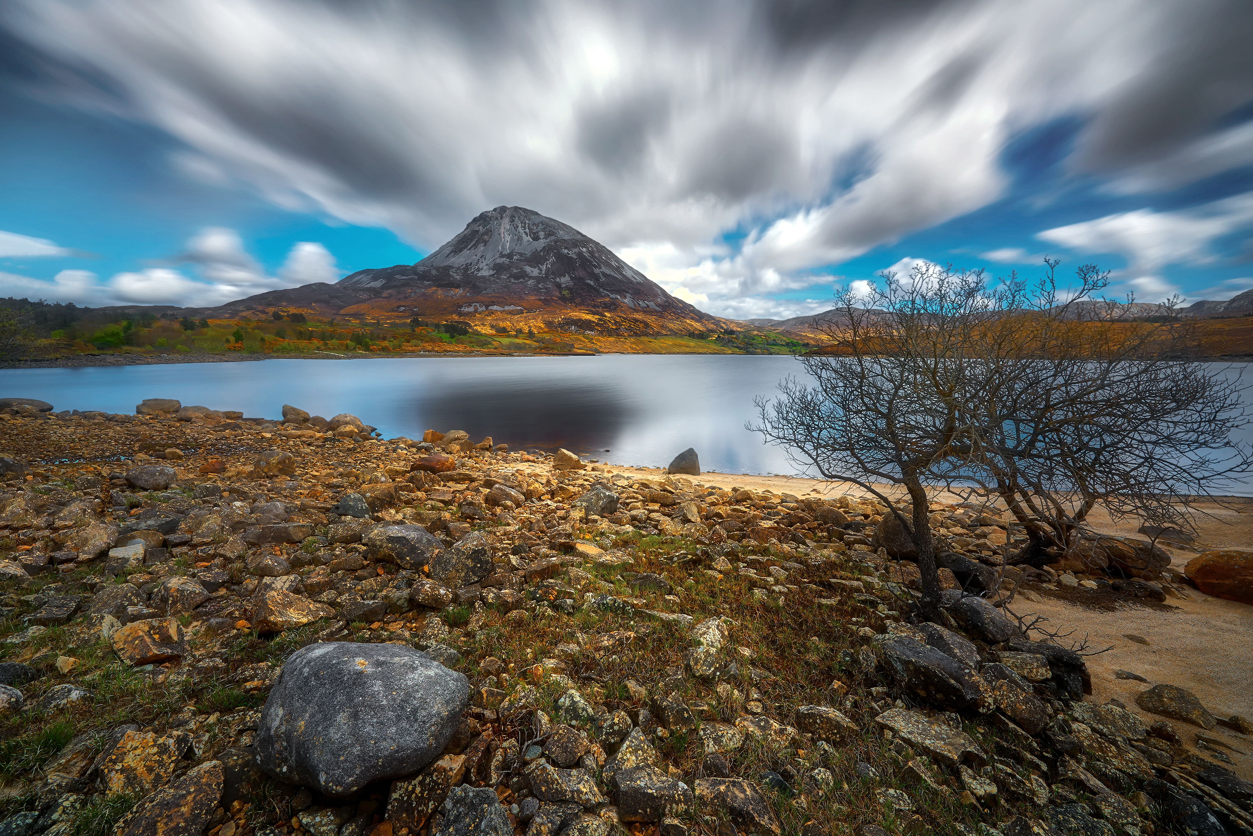 Mount Errigal, Co. Donegal, Ireland, reflected in blue lake surrounded by peatland in national park