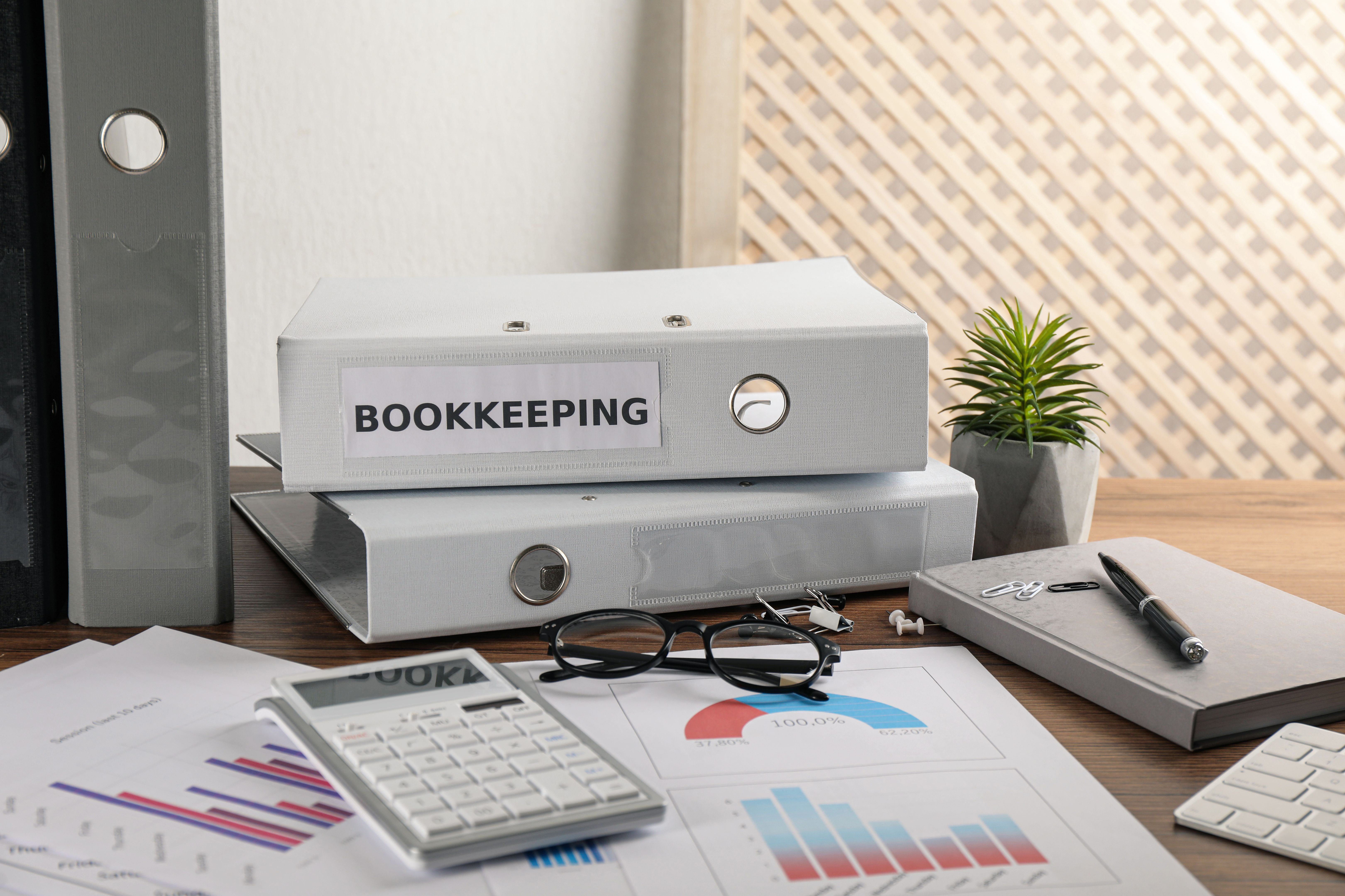 Bookkeeper's workplace with folders and documents on table Bookkeeper's workplace with folders and documents on table