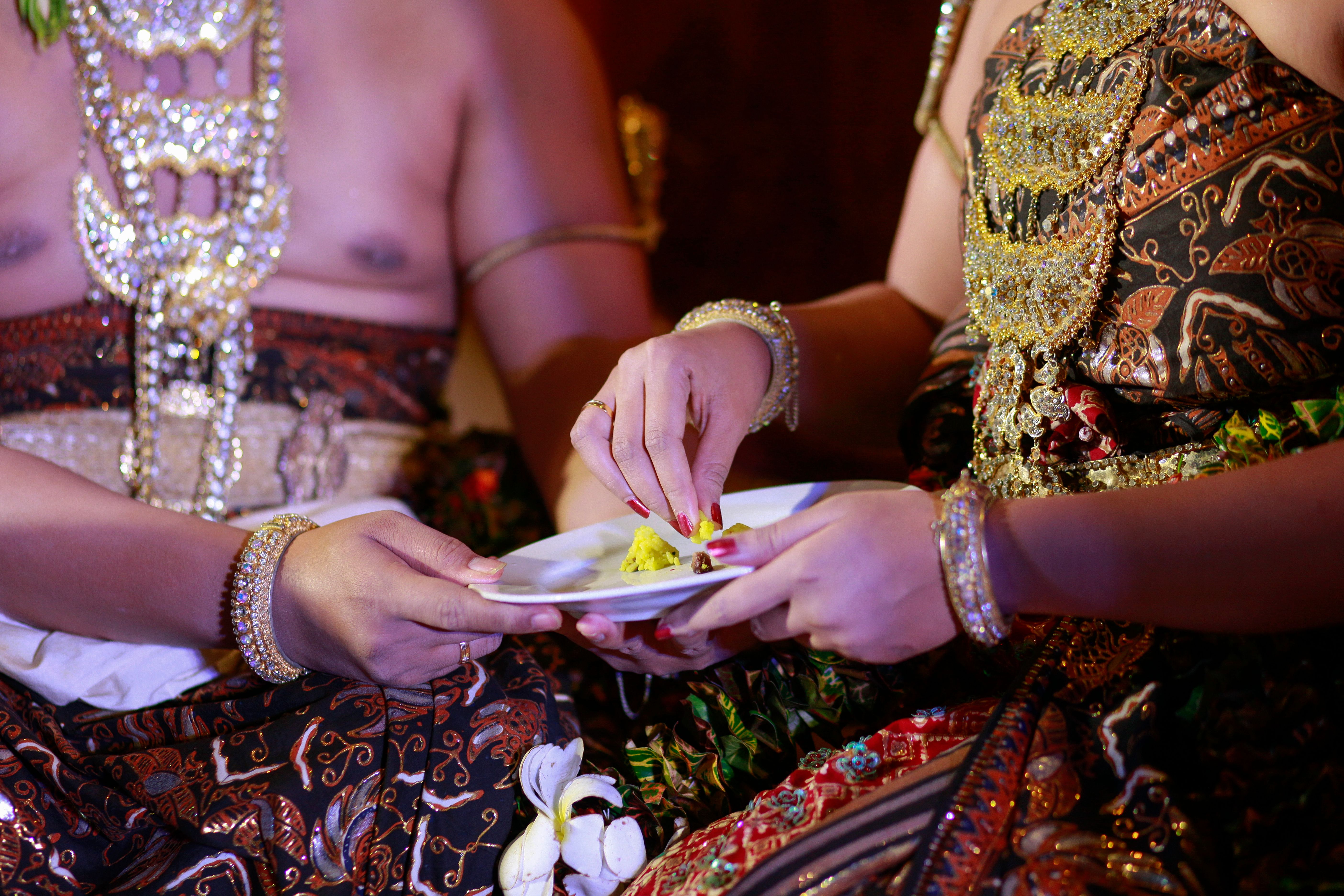 Bridal Couple who will follow the ceremony feed each other in the tradition of Javanese marriage Bridal Couple who will follow the ceremony feed each other in the tradition of Javanese marriage