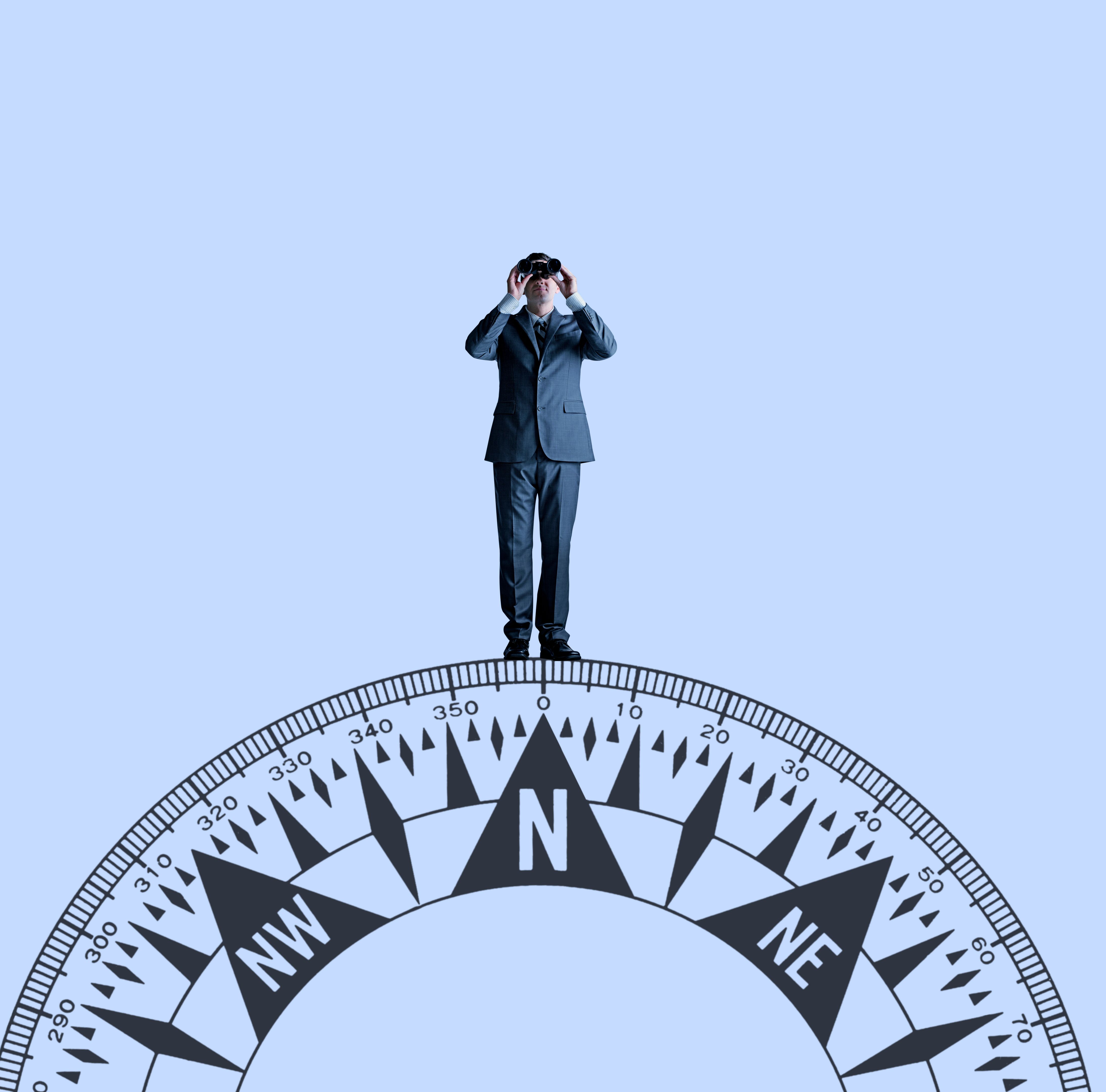 Businessman With Binoculars Standing On Top Of Compass