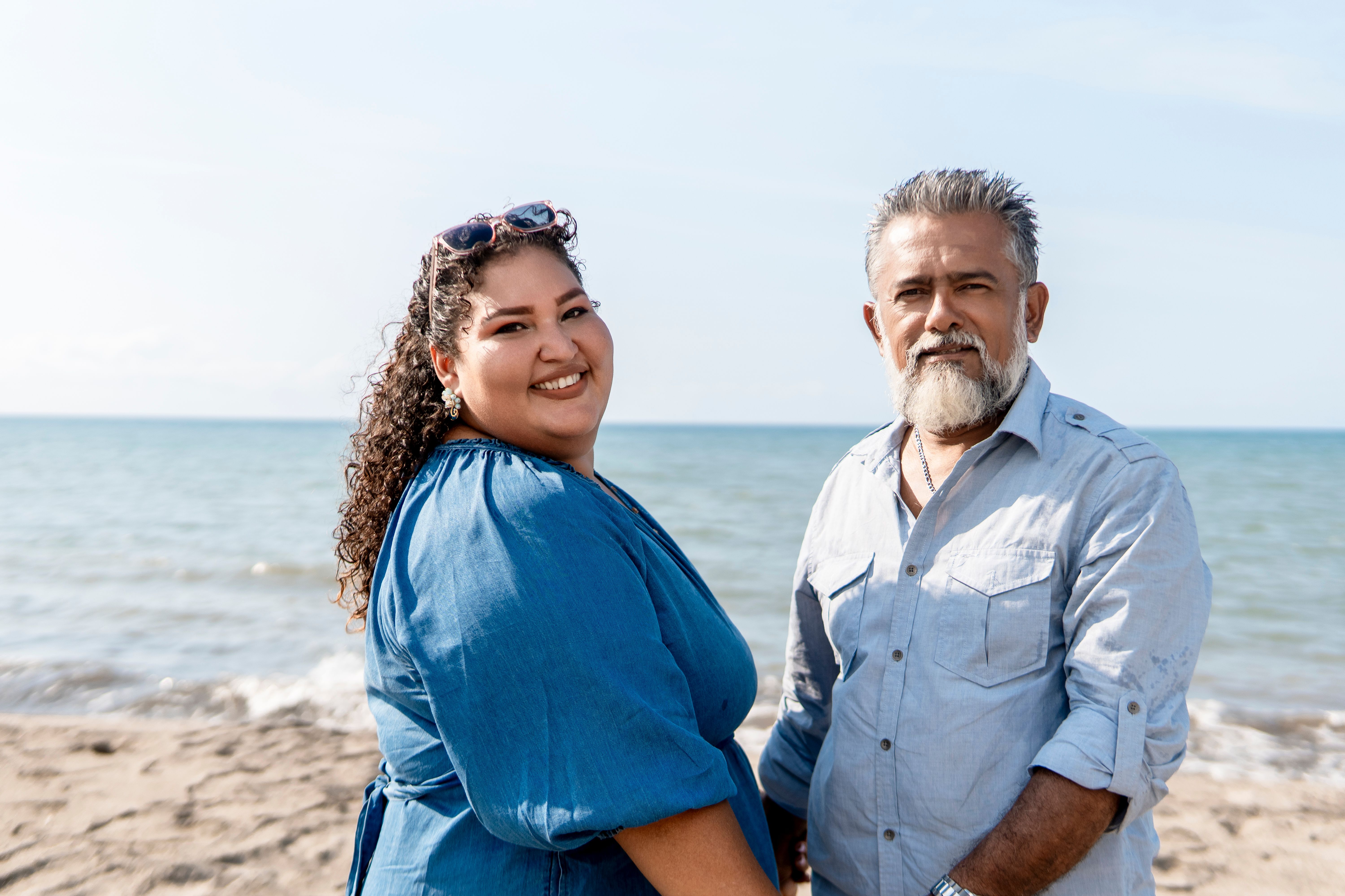 Happy couple enjoying sunny day at beach together
