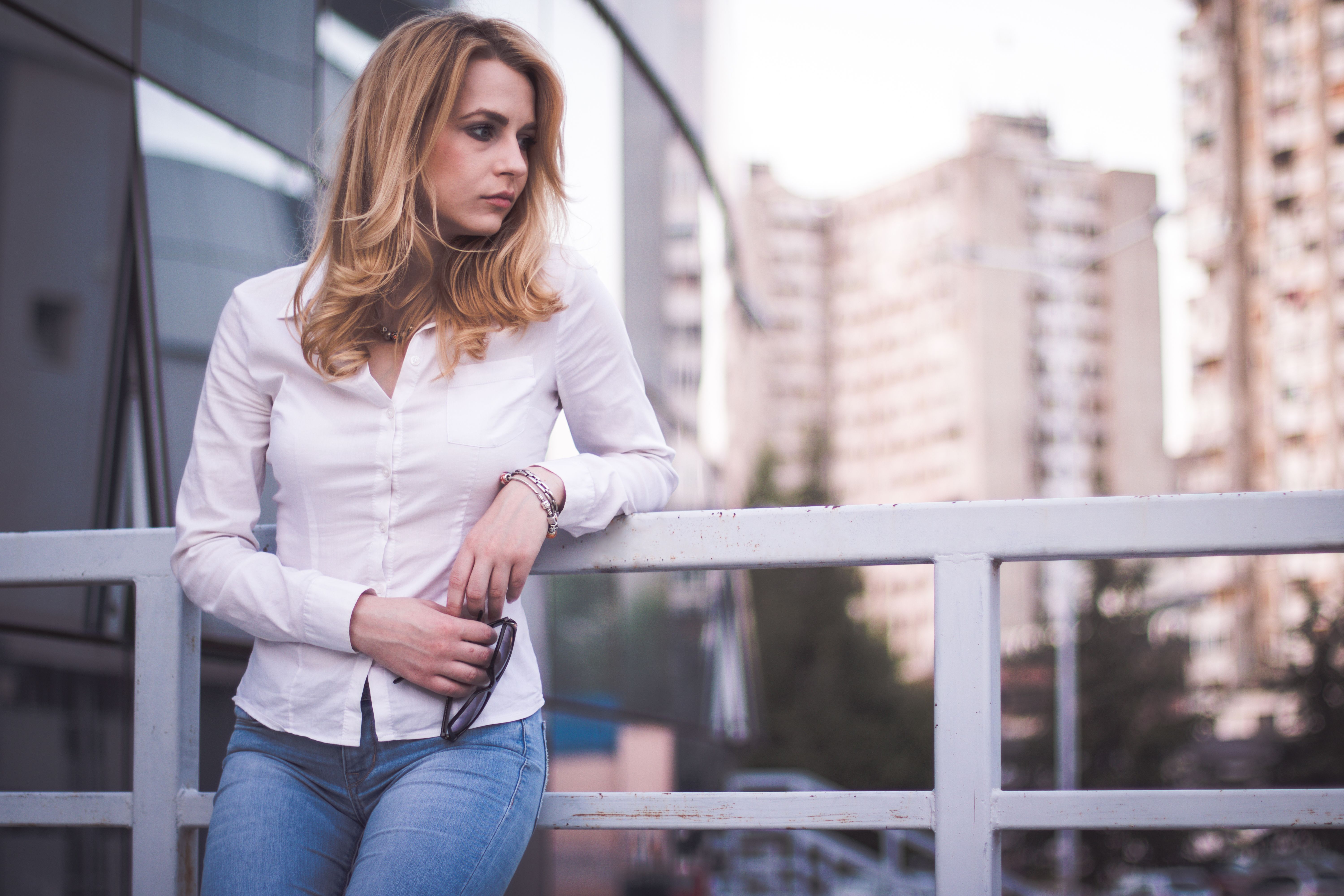 Woman leaning on metal fence Woman leaning on metal fence