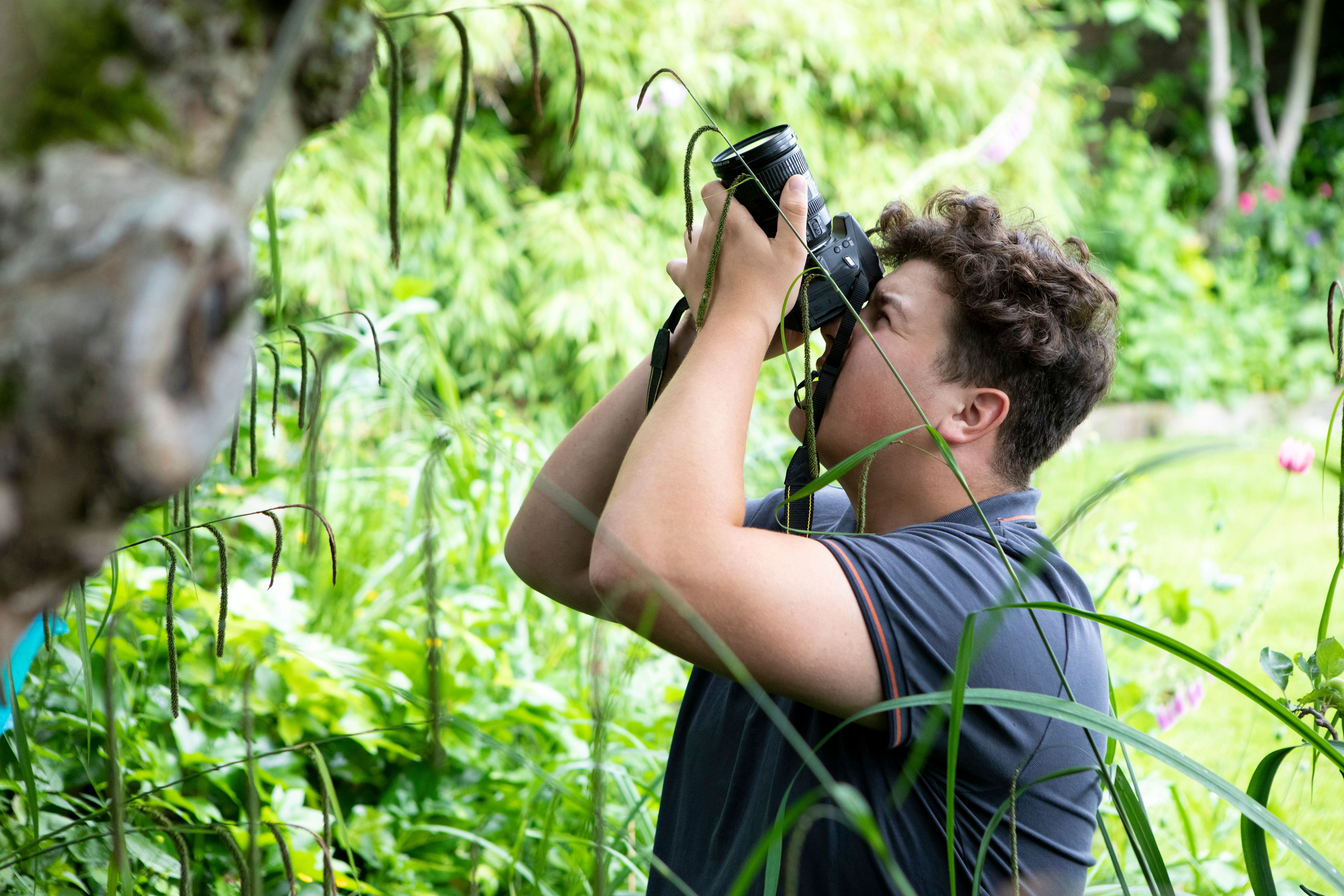 student taking photo garden
