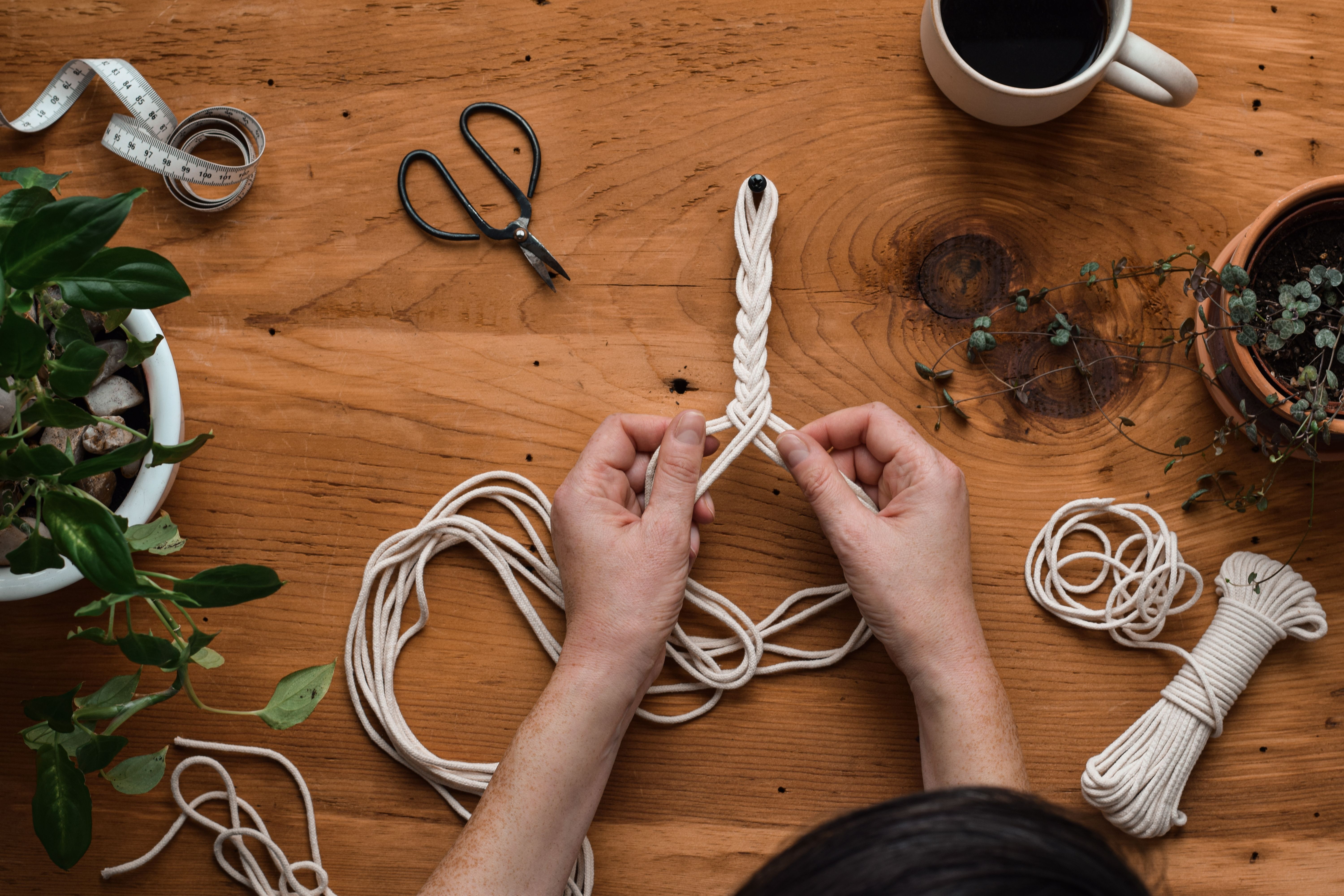 Woman making macrame plant hanger