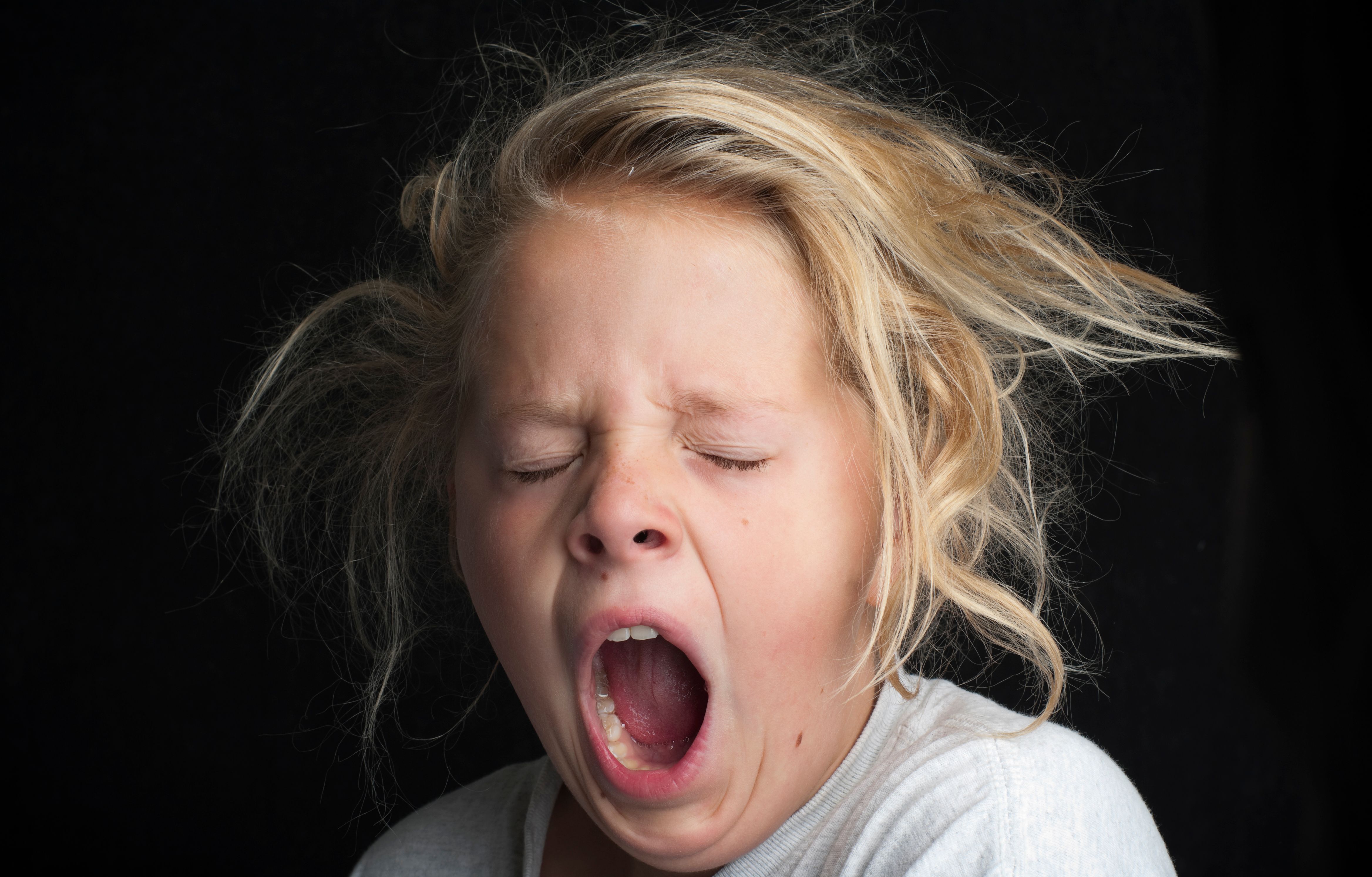Young girl, messy hair, tired and yawning Young girl, messy hair, tired and yawning