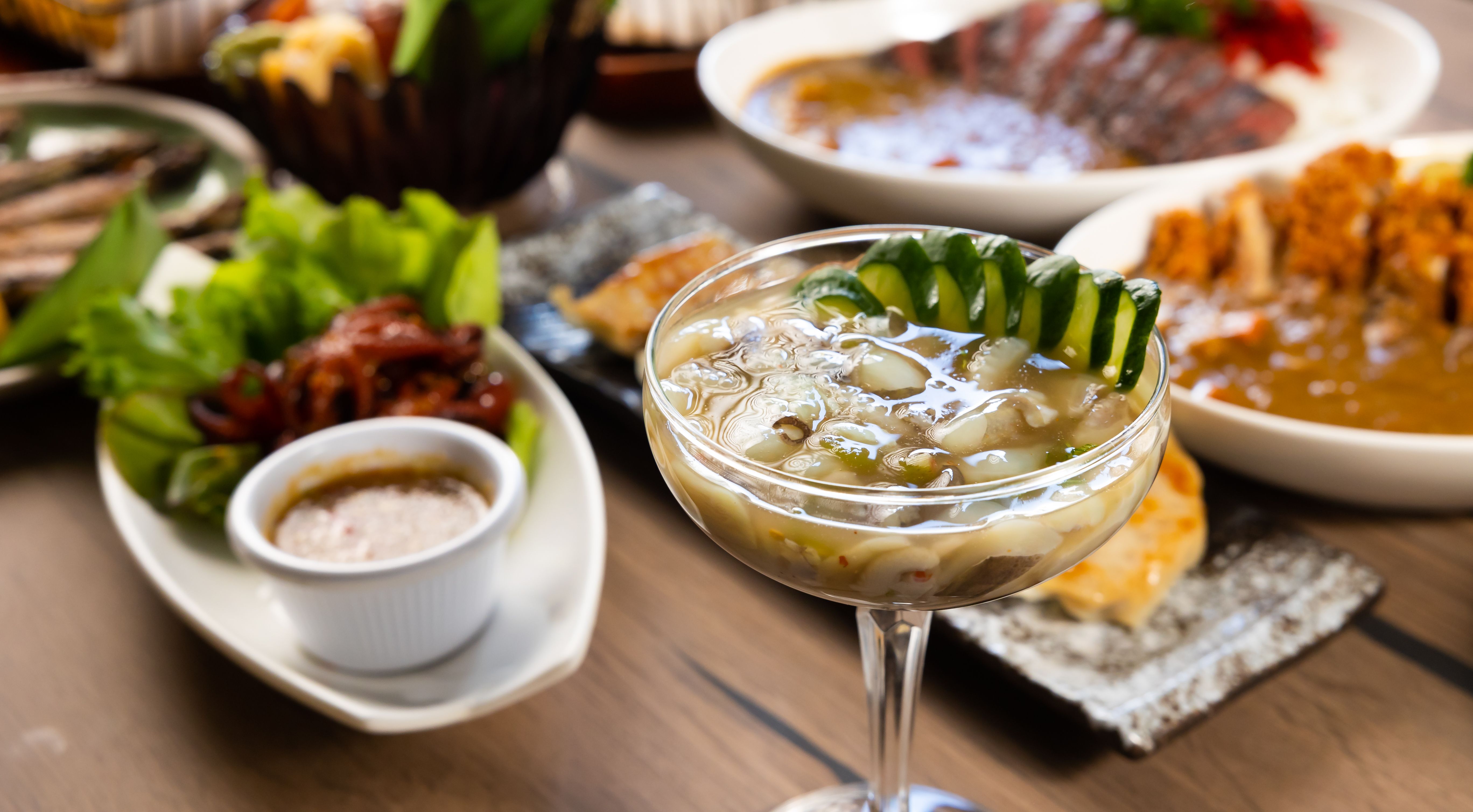 Raw squid mixed with wasabi. Top view many traditional gourmet japanese food dishes on wood table. Japanese food isolated on wood background