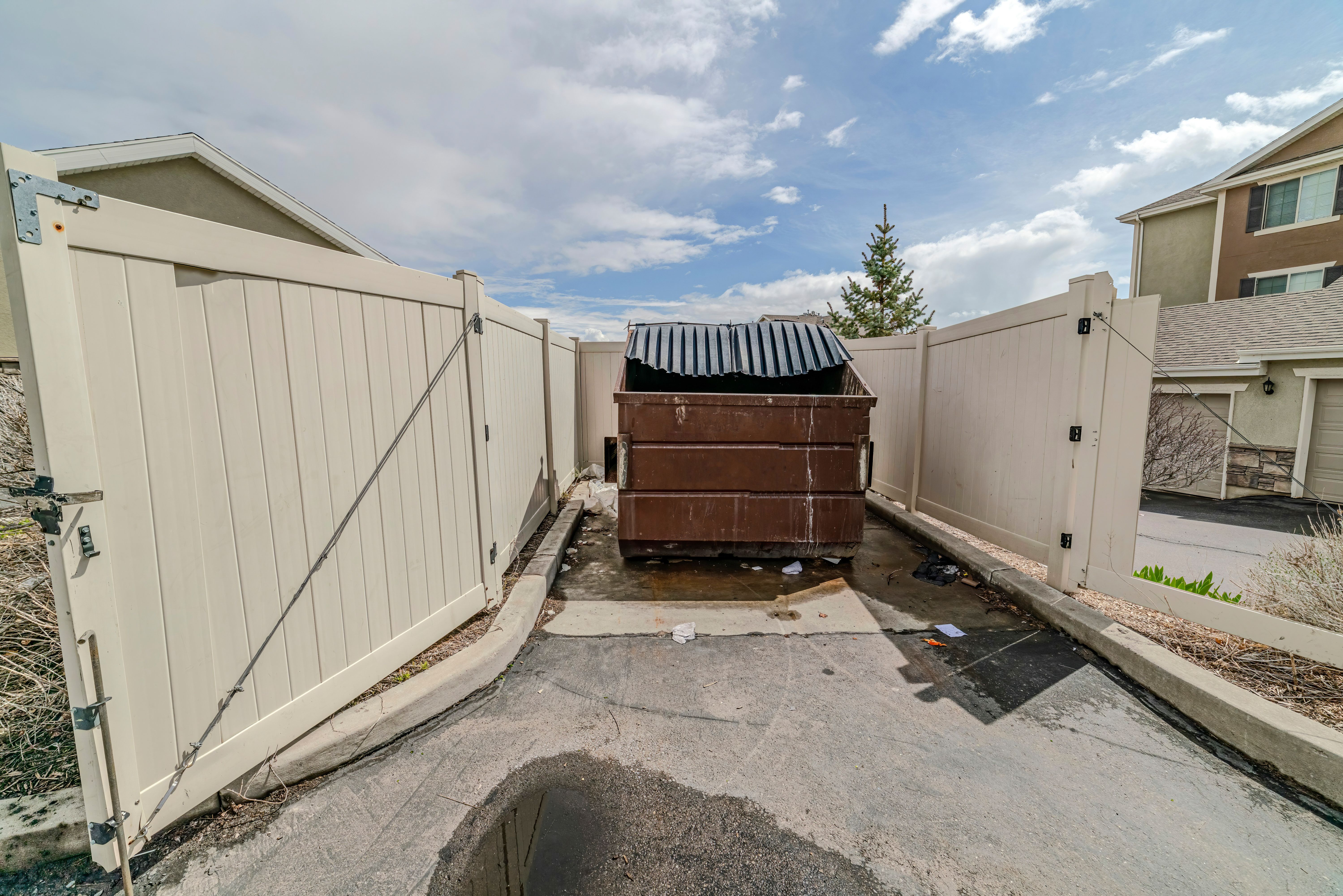 Wooden trash can surrounded by a wooden fence