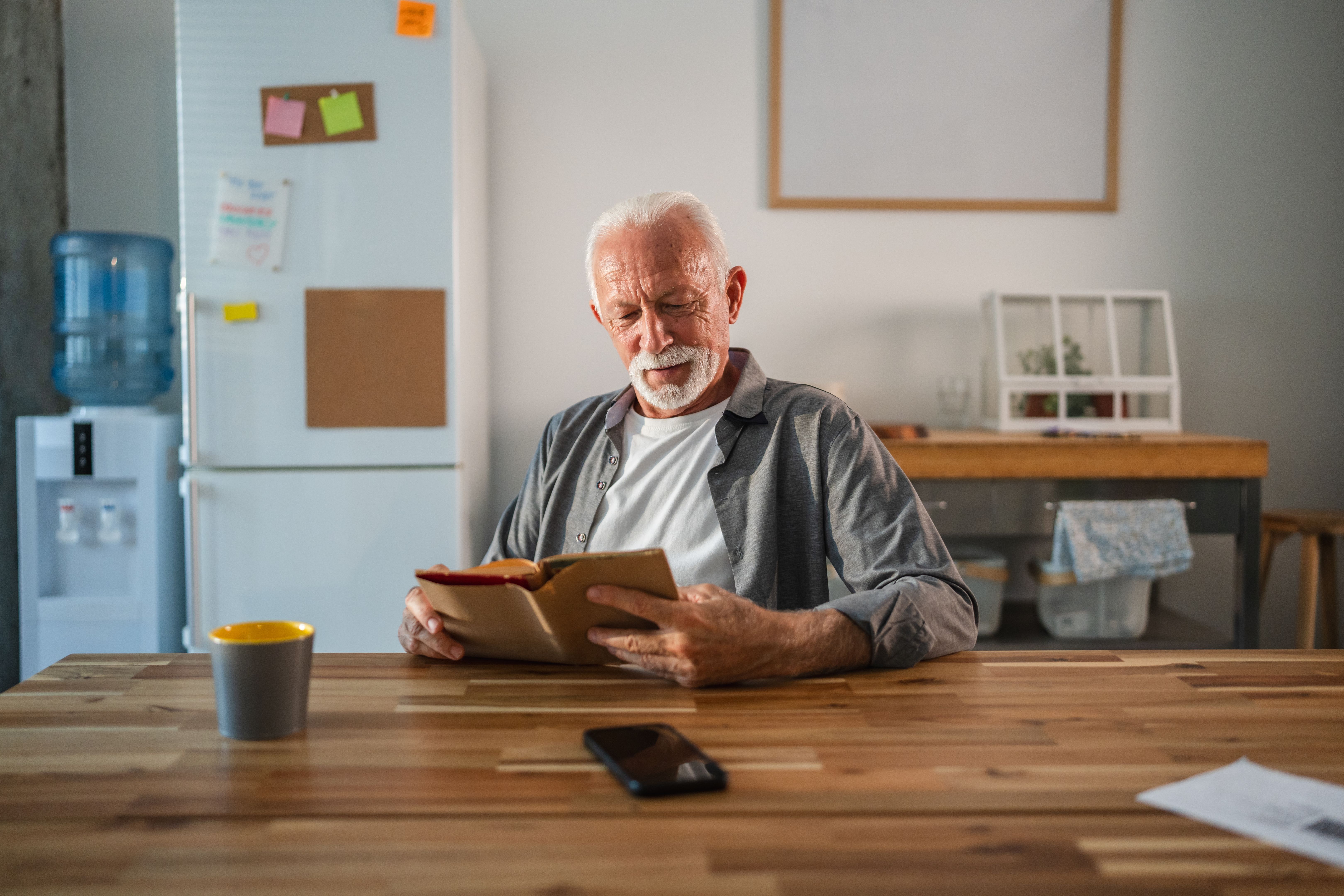 elderly man reading book