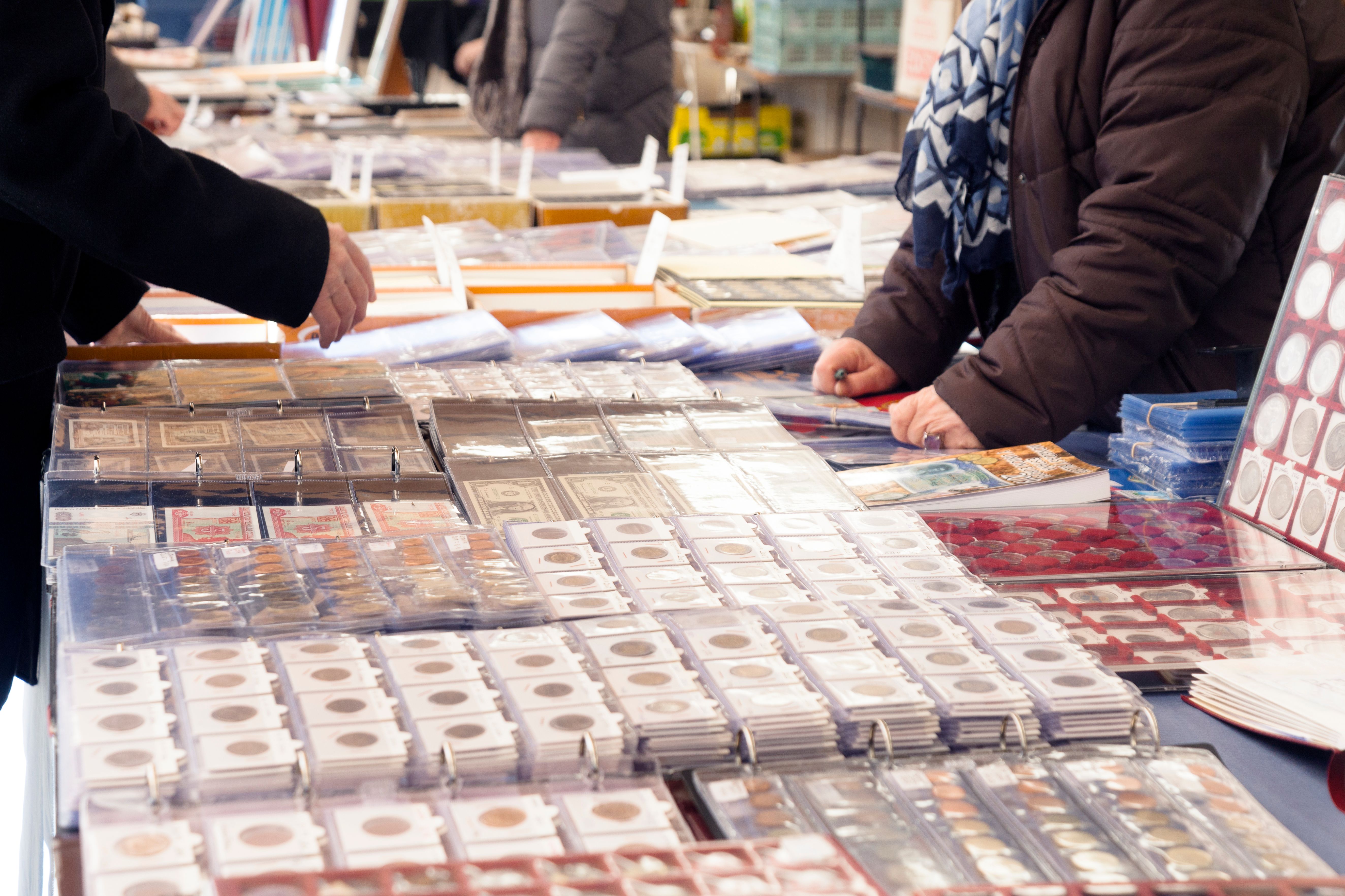 Customers buying old coins in the flea market