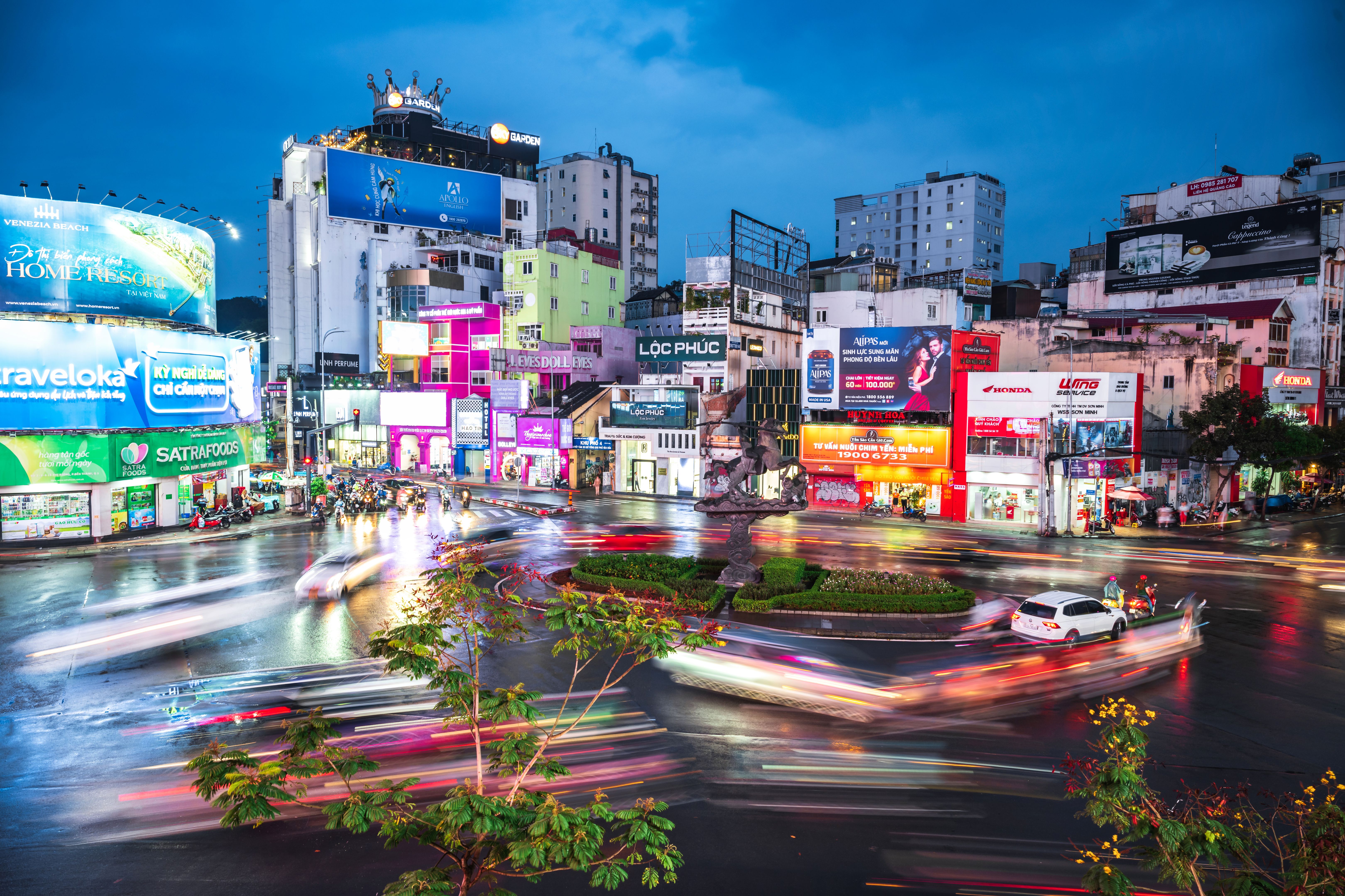 crowds of motor scooter at traffic circle in Sai gon at blue hour