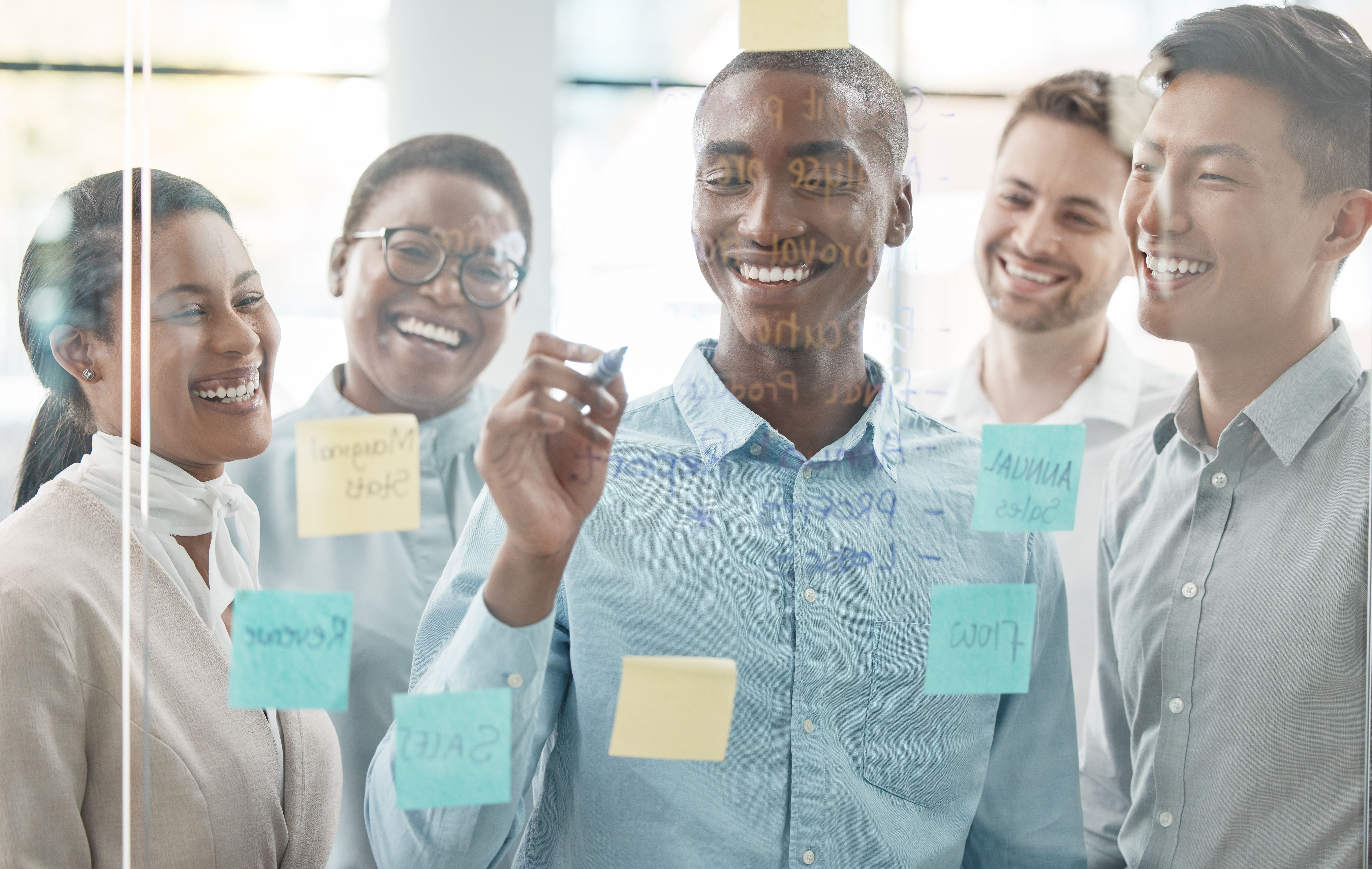 Planning, teamwork and sticky note with business people in meeting for goals, project management and idea. Collaboration, vision and strategy with employee writing on glass window for scrum target