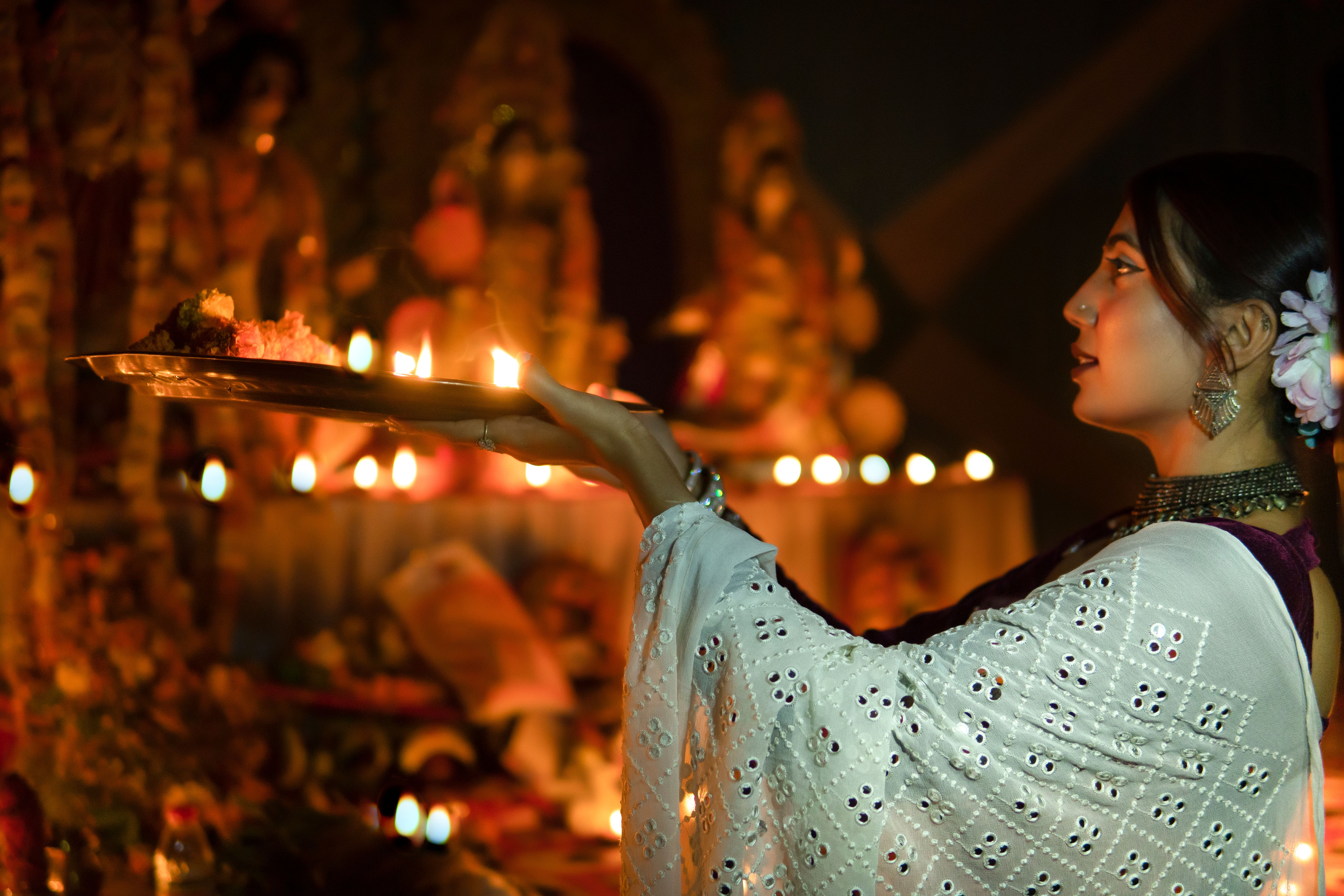 Traditional Indian woman holding Puja Thali doing worship of the goddess. Traditional Indian woman holding Puja Thali doing worship of the goddess.