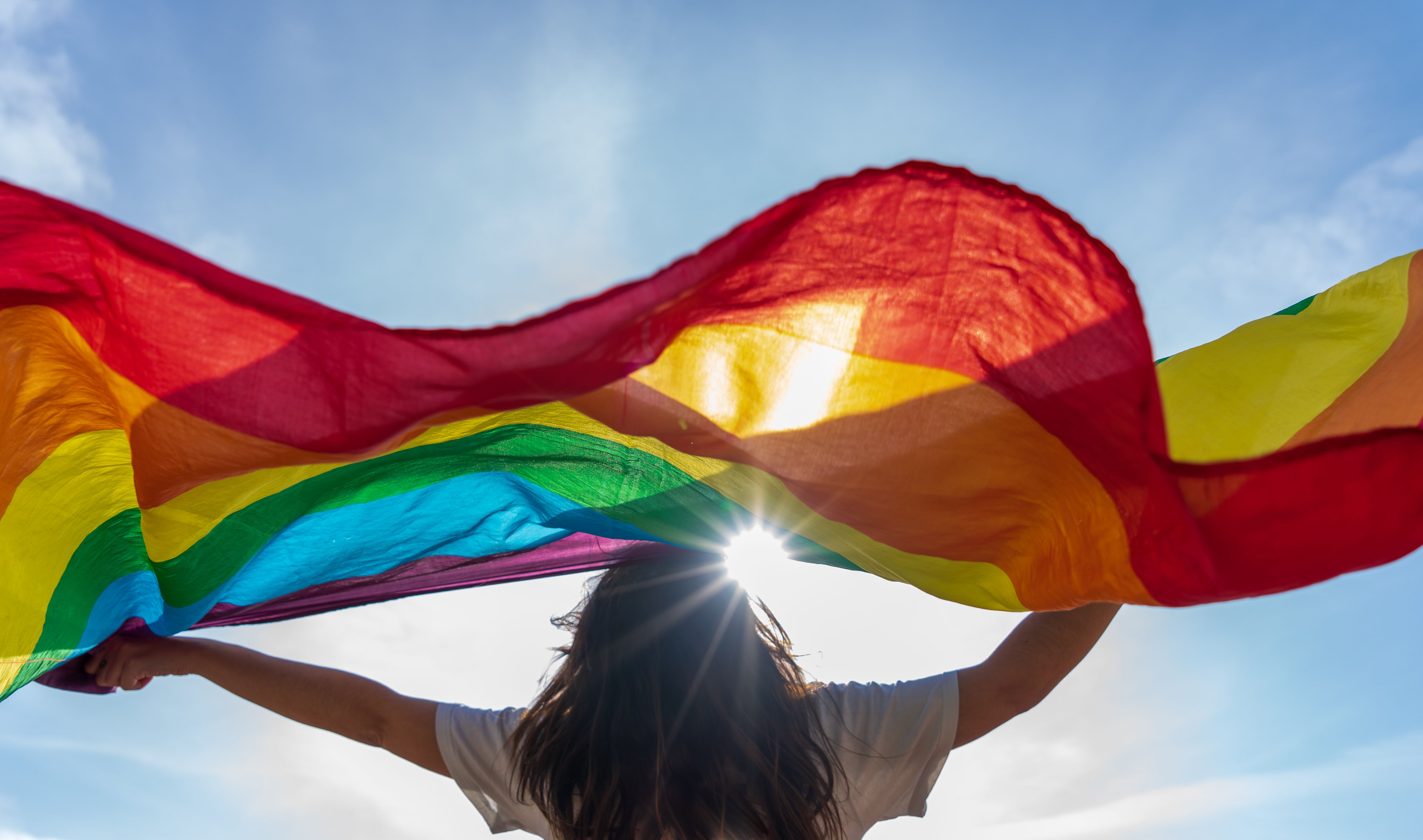 Young woman waving lgbti flag Young woman waving lgbti flag