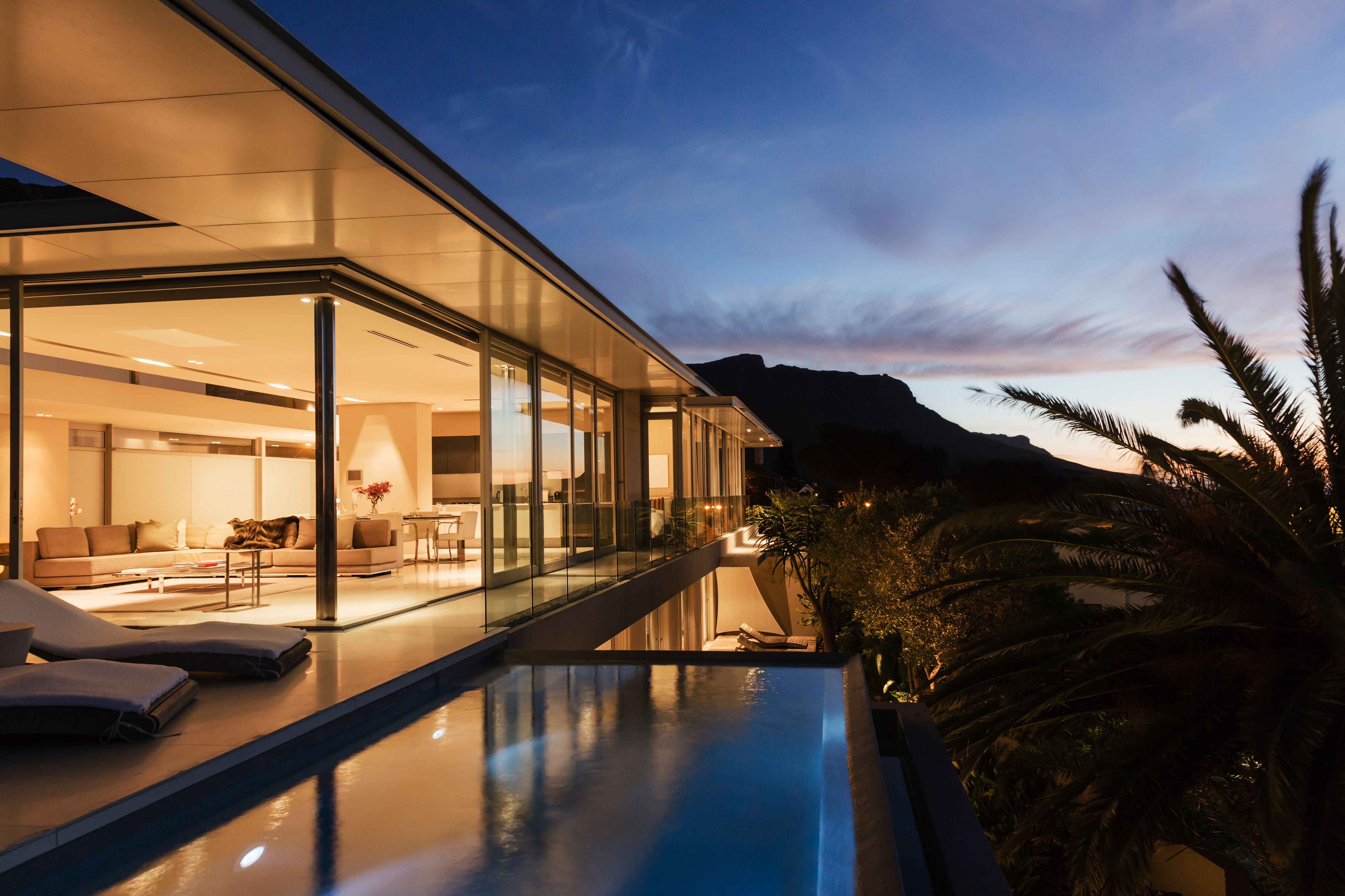 Modern house overlooking mountains at dusk