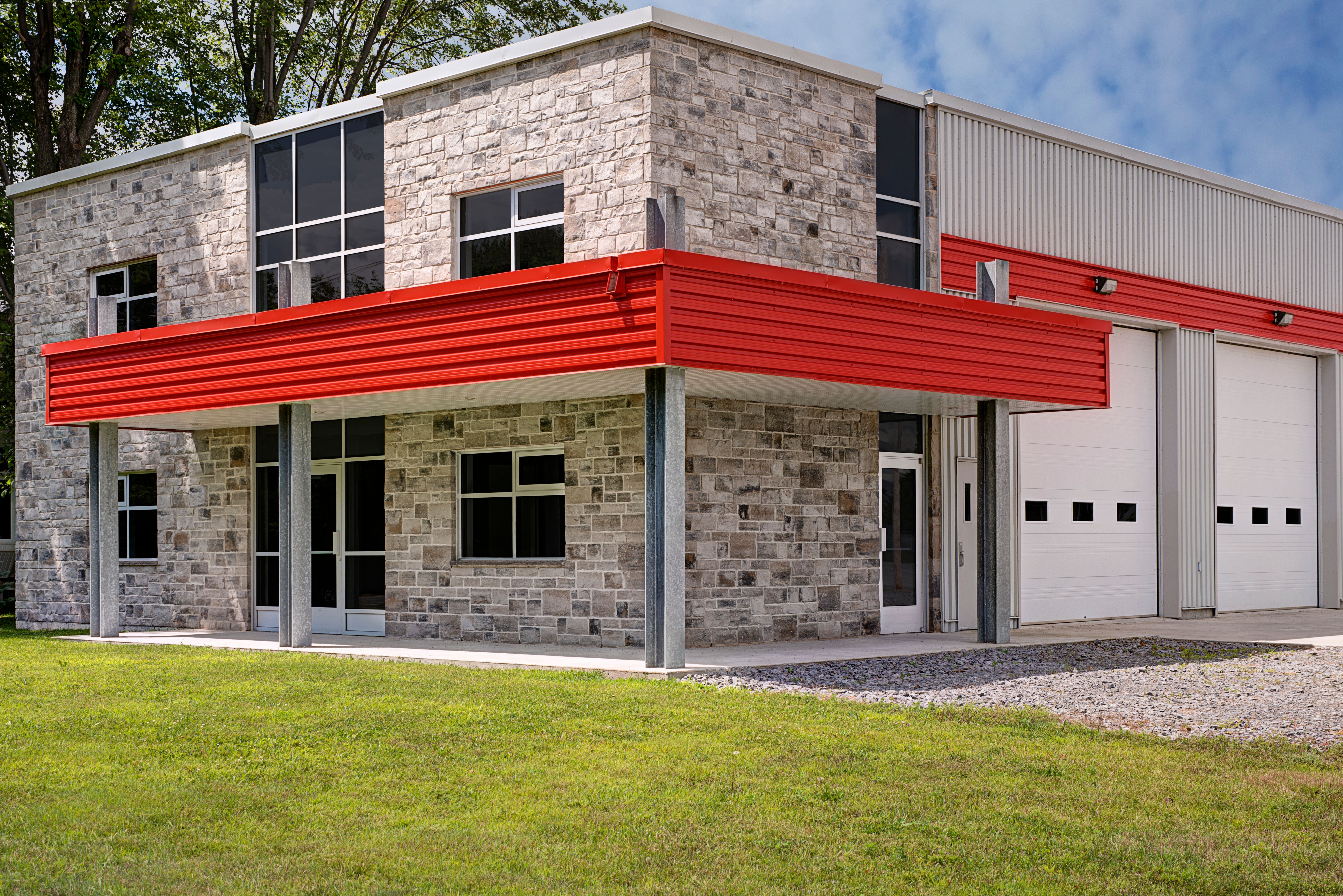 Industrial warehouse entrance and white roller doors on the side.