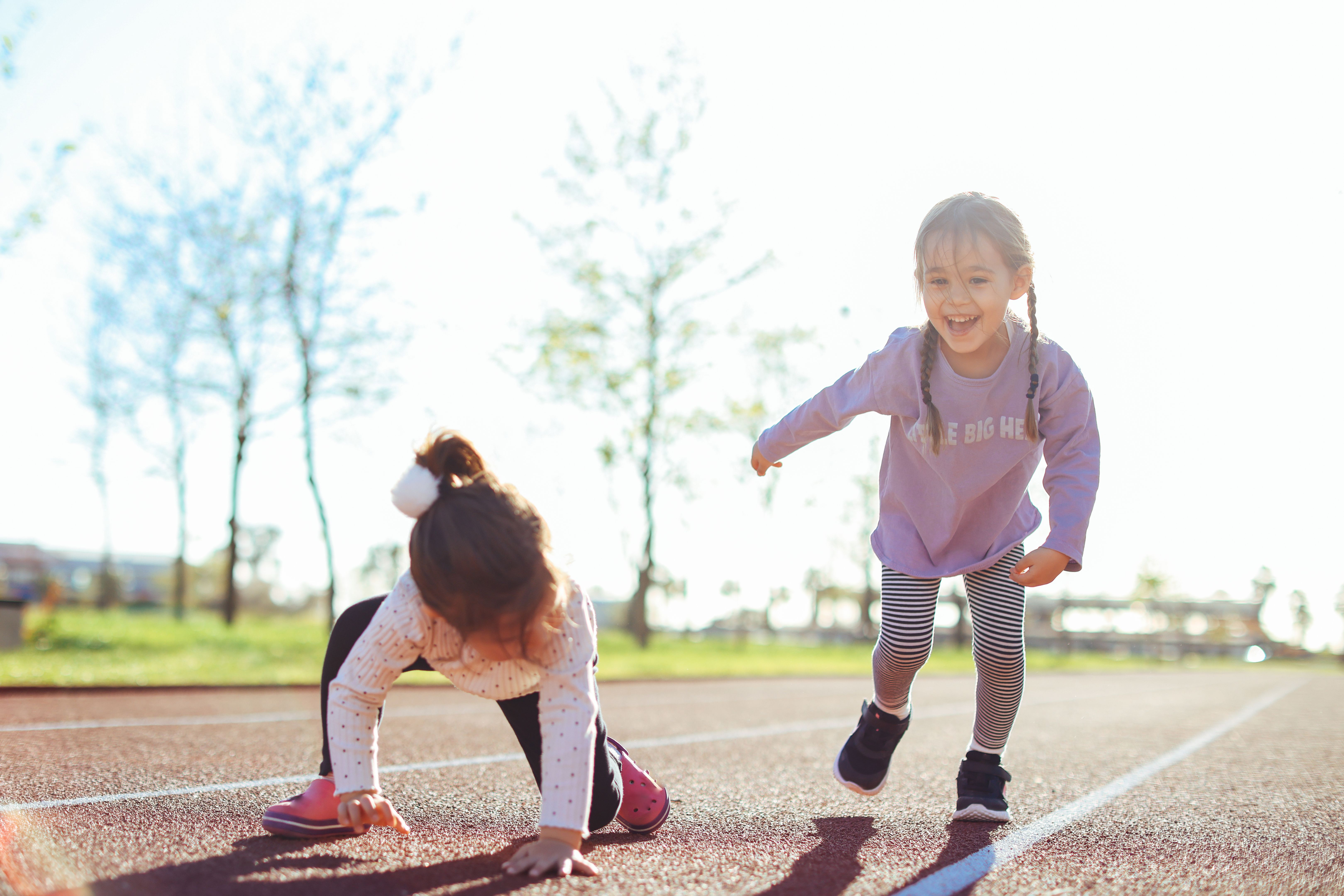 Little girls preparing for run on the running track