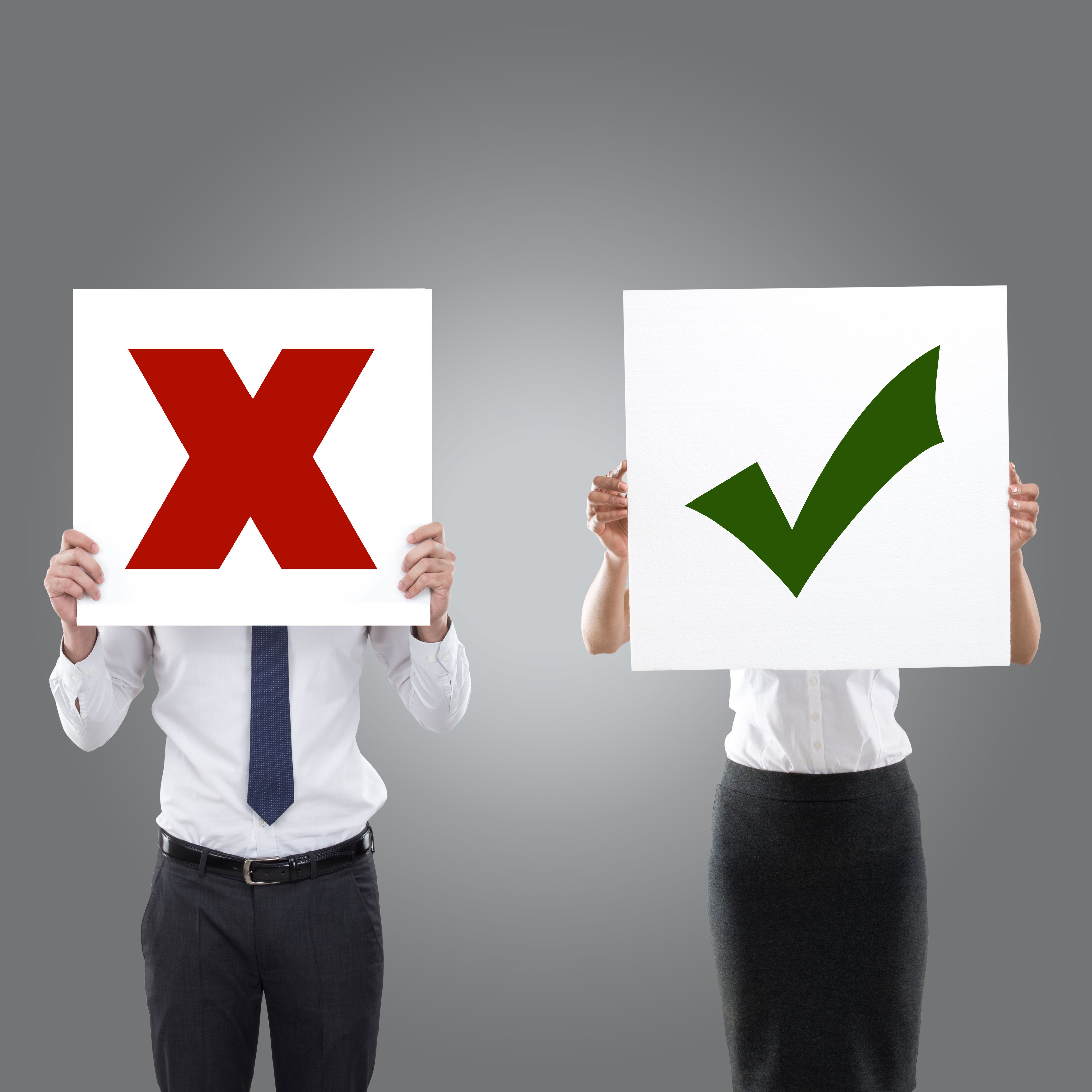 Business people holding wrong and right sign Business people holding wrong and right sign