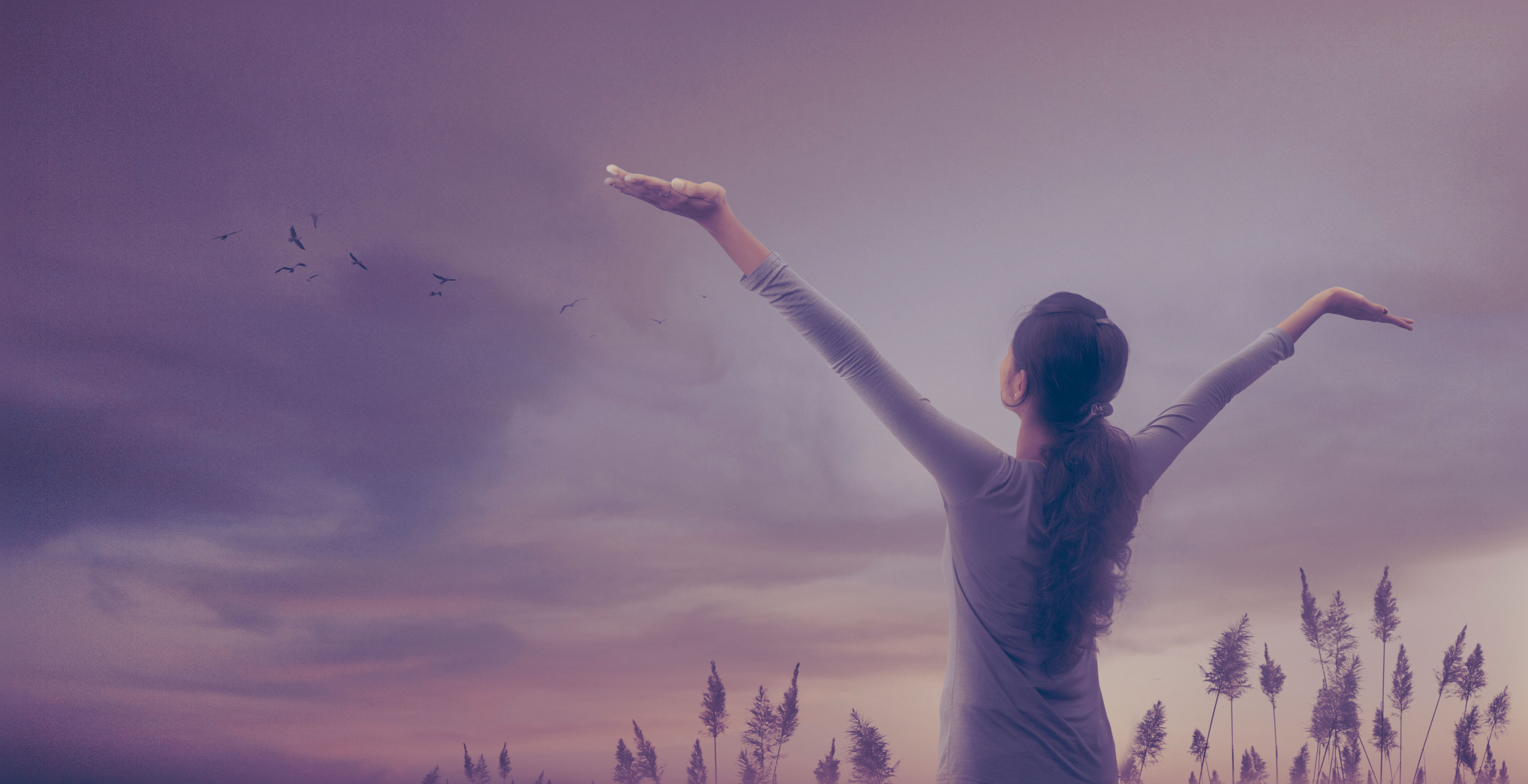 Young girl spreading hands with joy and inspiration facing the sky Young girl spreading hands with joy and inspiration facing the sky