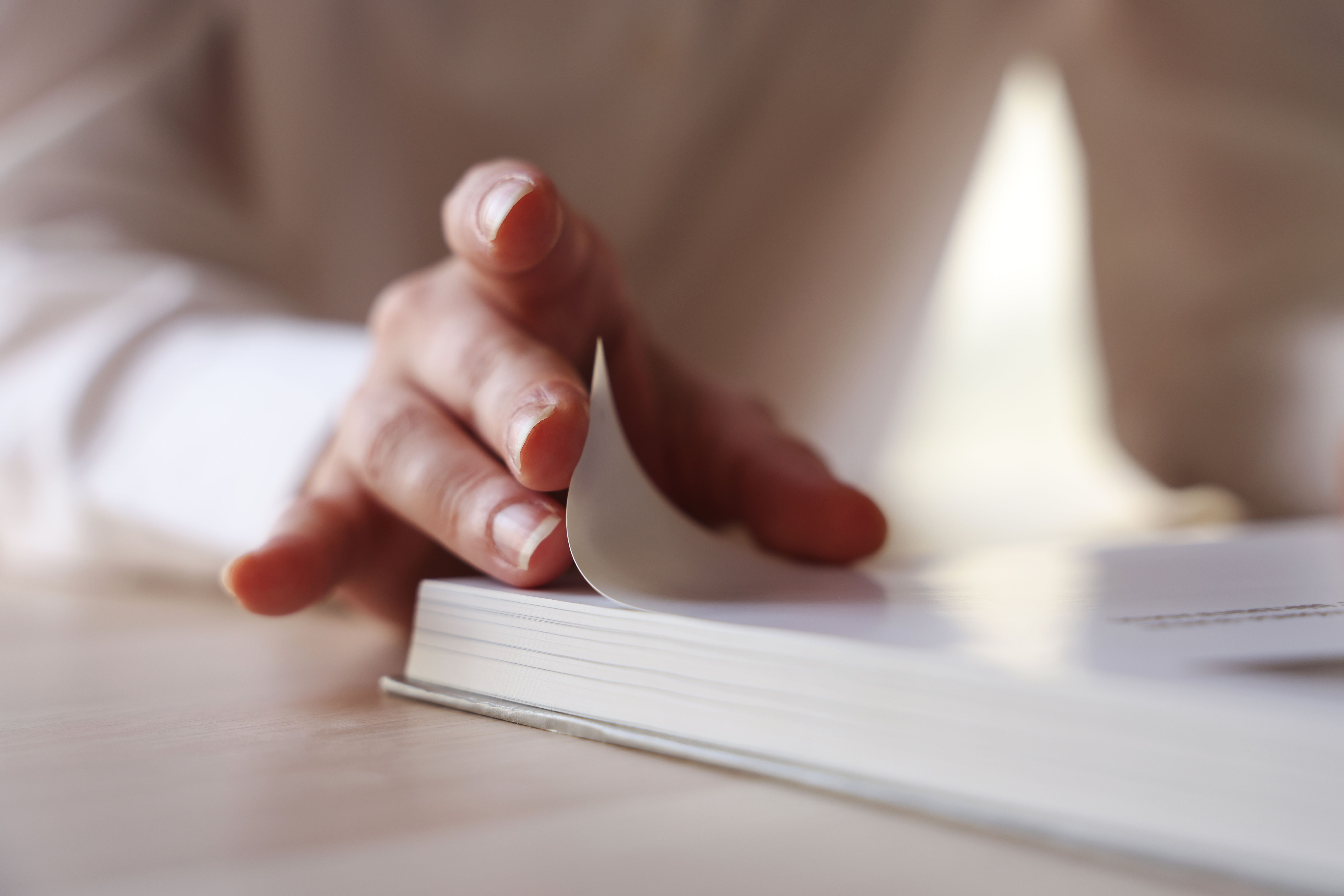 Hand turns magazine paper Hand turns magazine paper