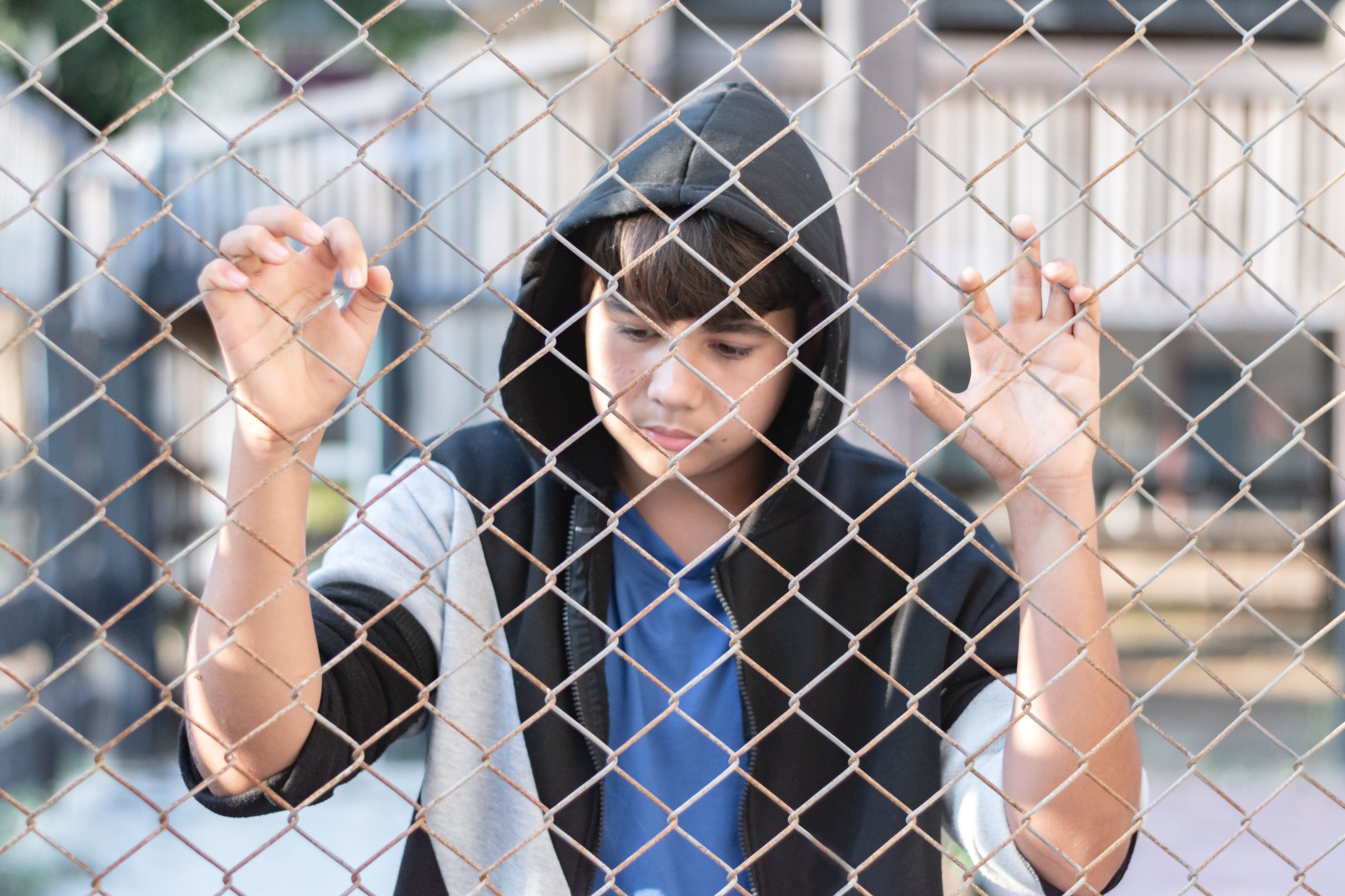 Asian youngster lifestyles looking through fence easement