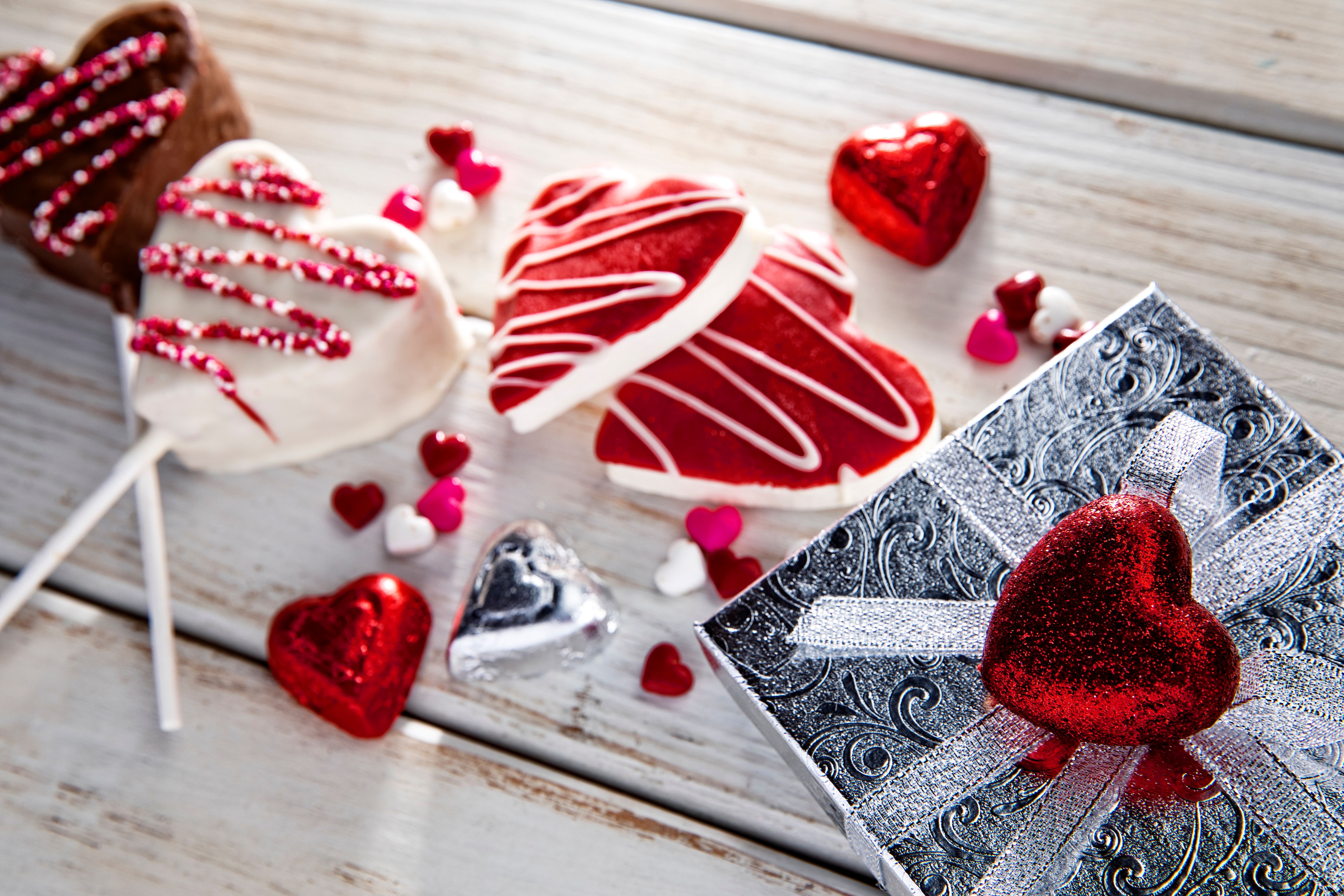 Heart Shape Cookies and chocolate foil candy on white weathered wood background with gift