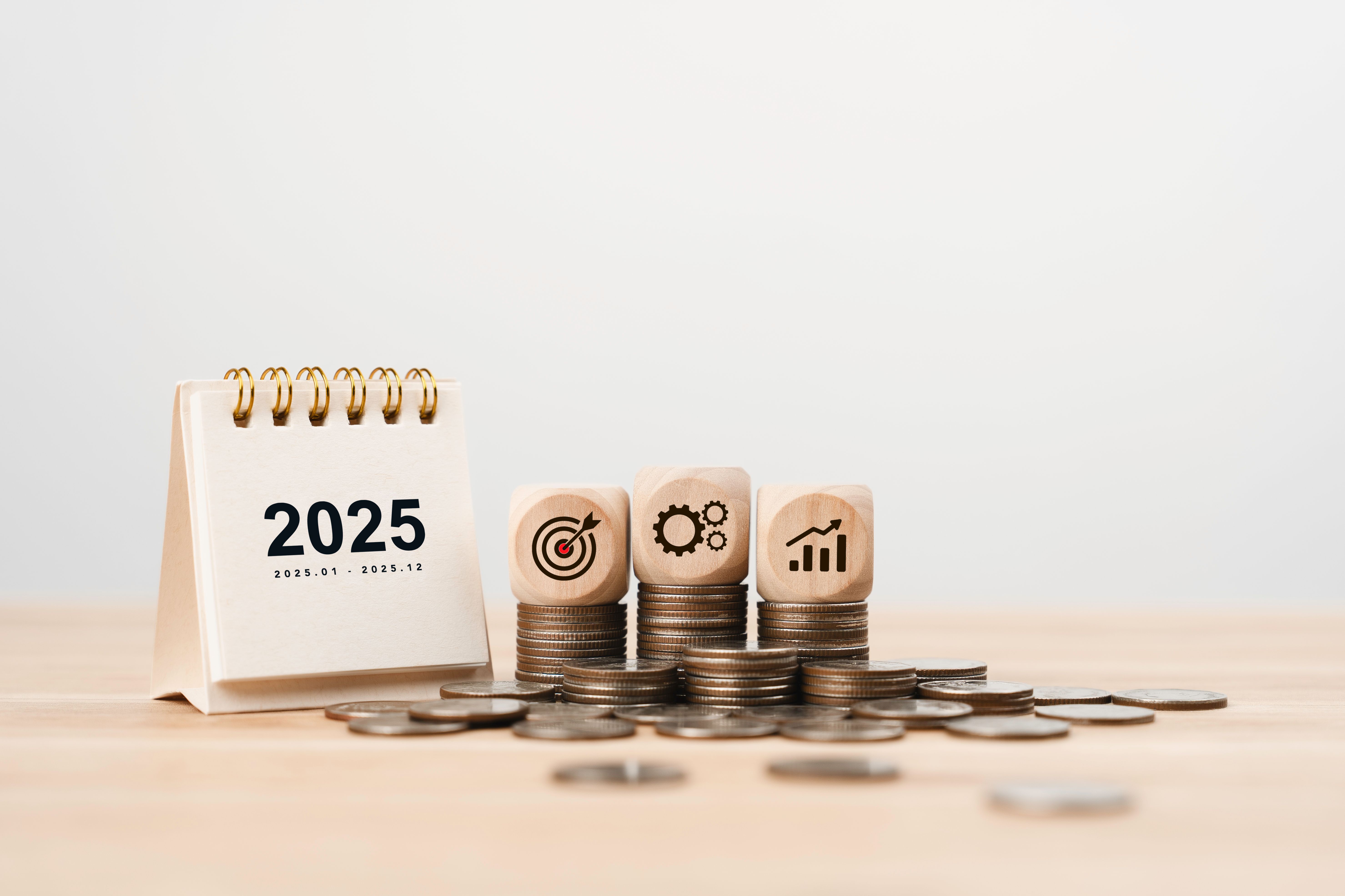 2025 Calendar and wooden cube with goal plan action icon on growth coin. New year resolution of finance investment concept. financial annual plan for save money, Budget, tax, financial and savings
