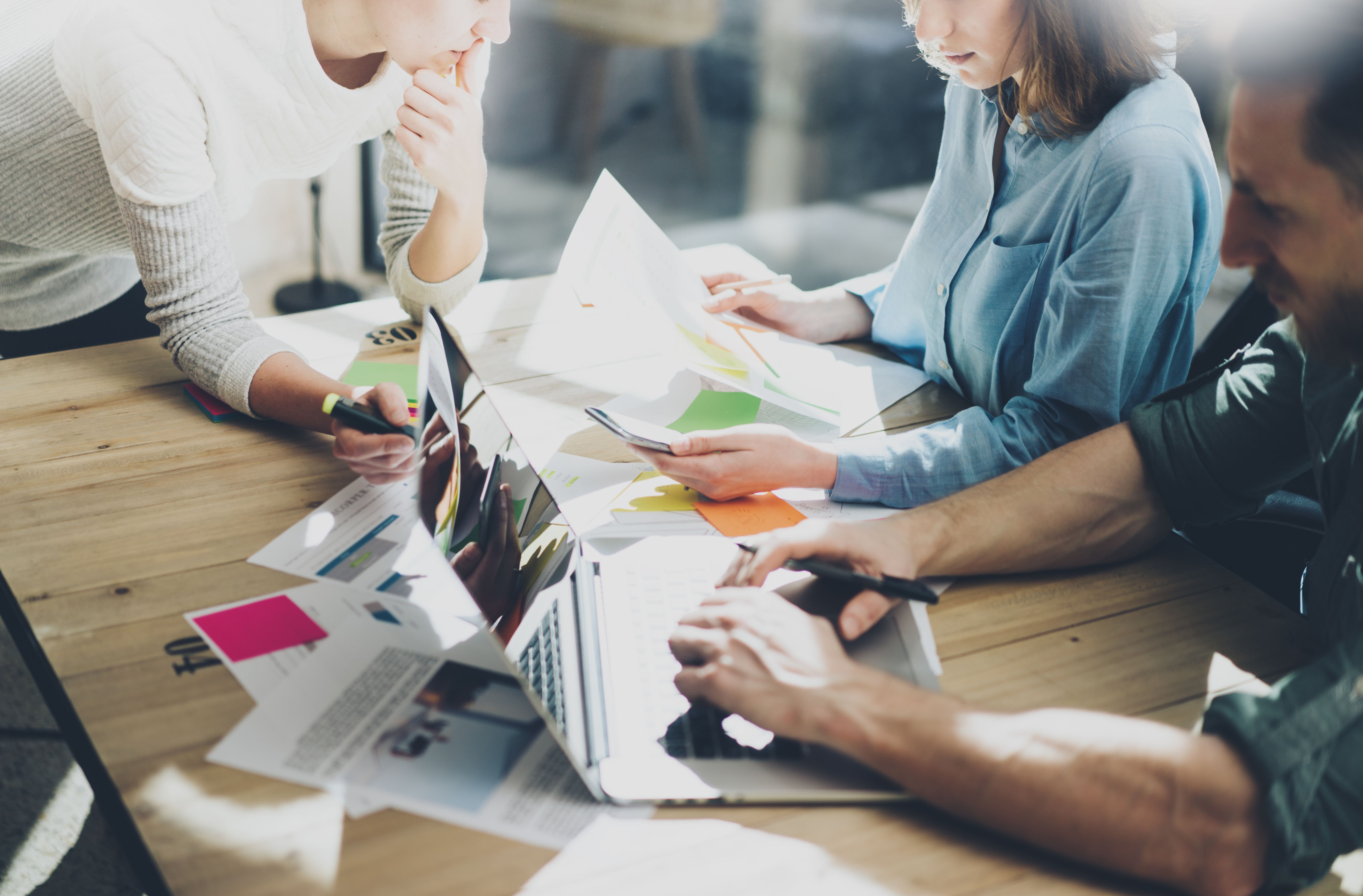 Concept of presentation new business project.Group young coworkers discussing ideas with each other in modern office.Horizontal, blurred background. Concept of presentation new business project.Group young coworkers discussing ideas with each other in modern office.Horizontal, blurred background.