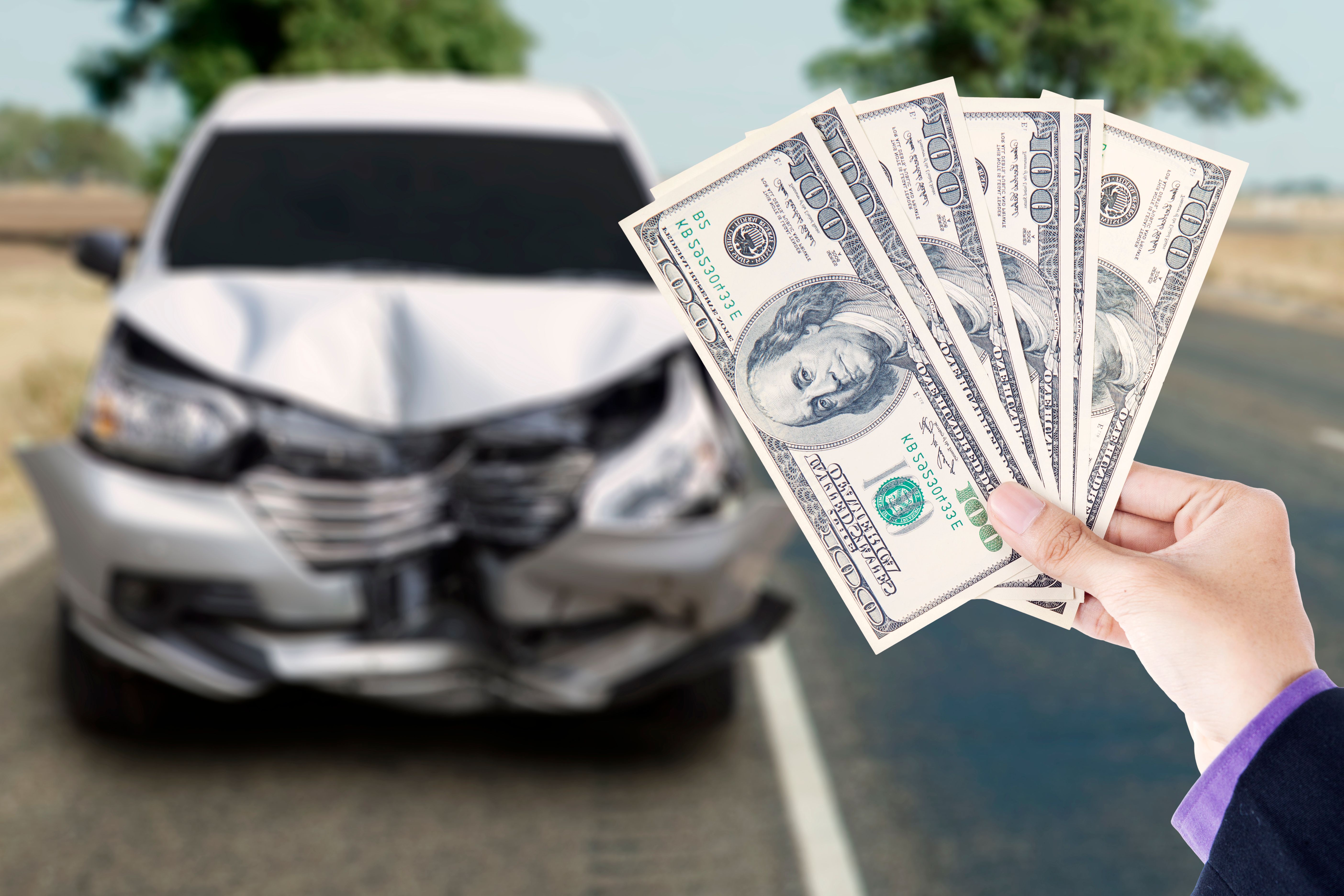 Businessman with dollar and broken car