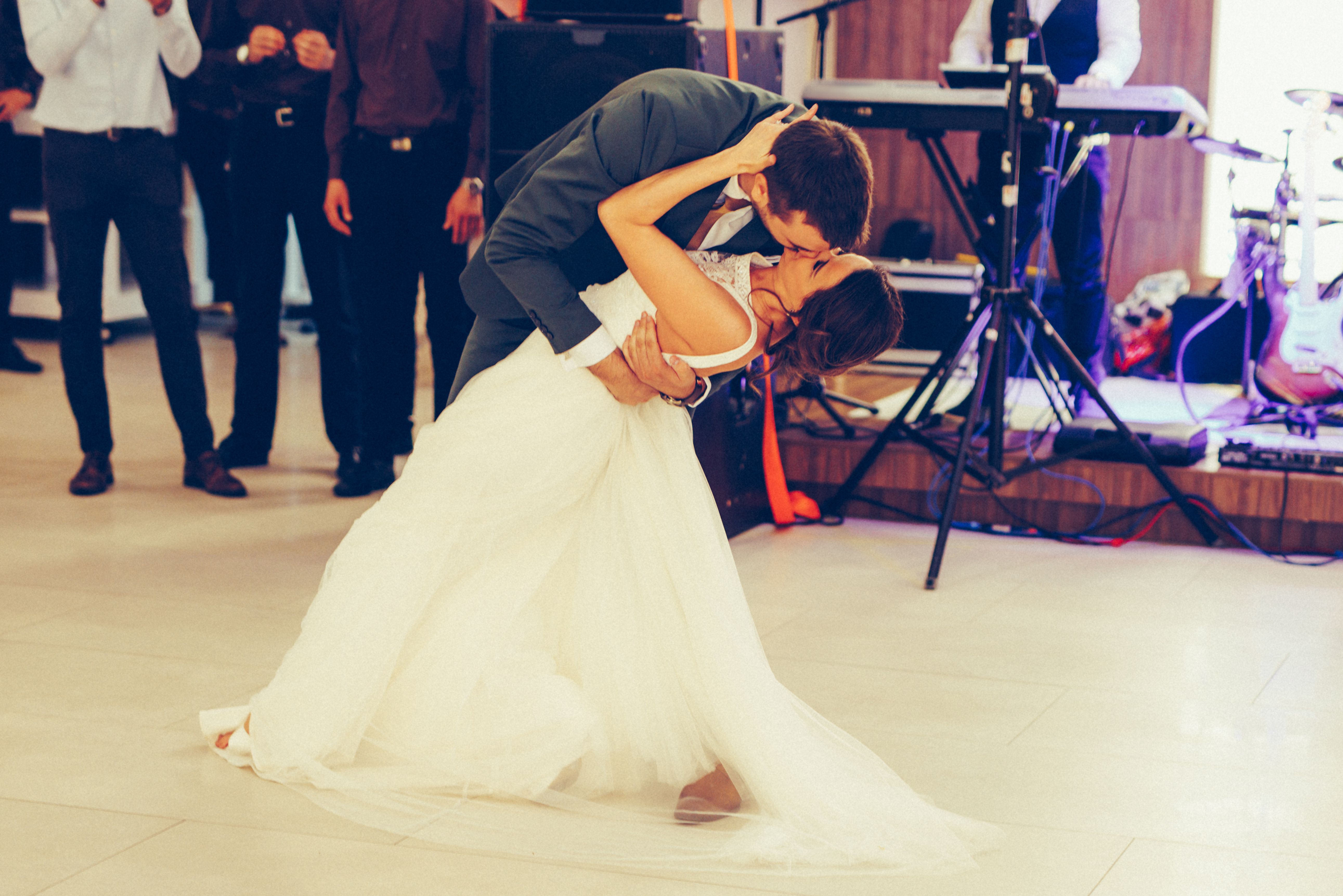 Newlyweds dancing on dance floor during wedding ceremony