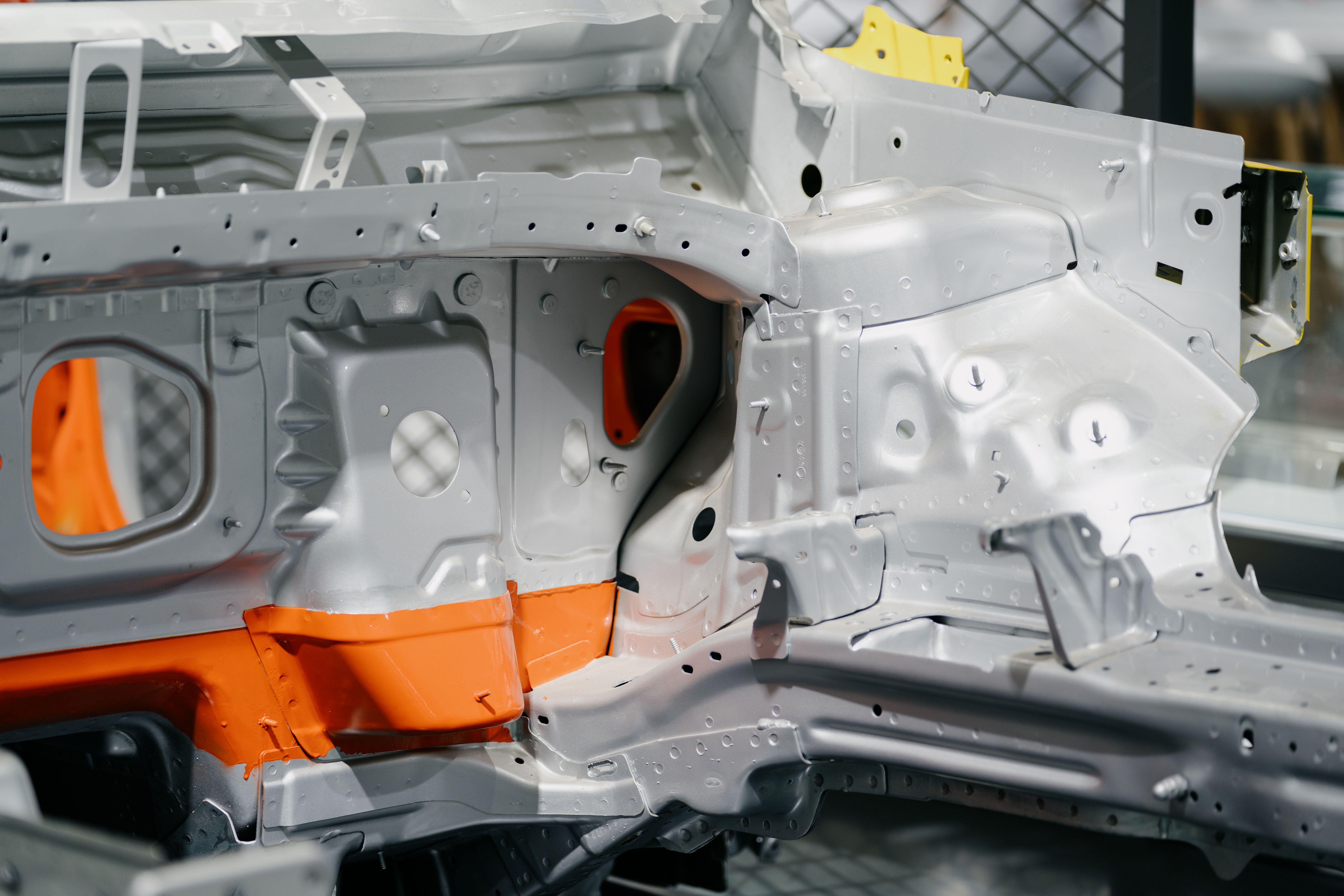 The car factory is manufacturing cars.