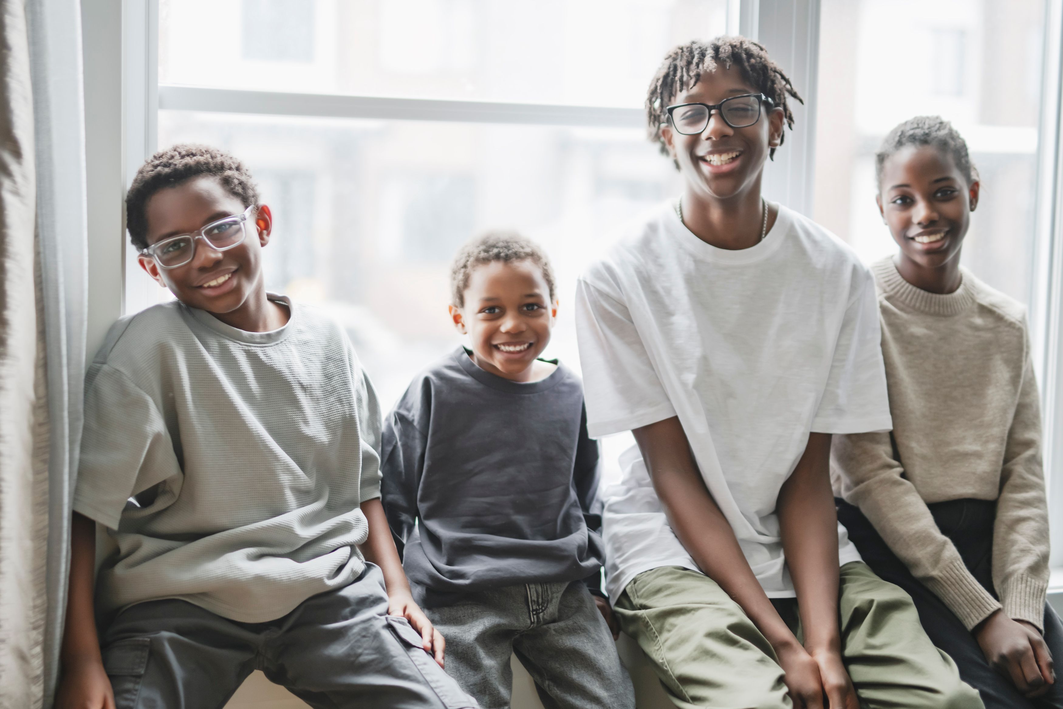 four childs having great time on the livingroom