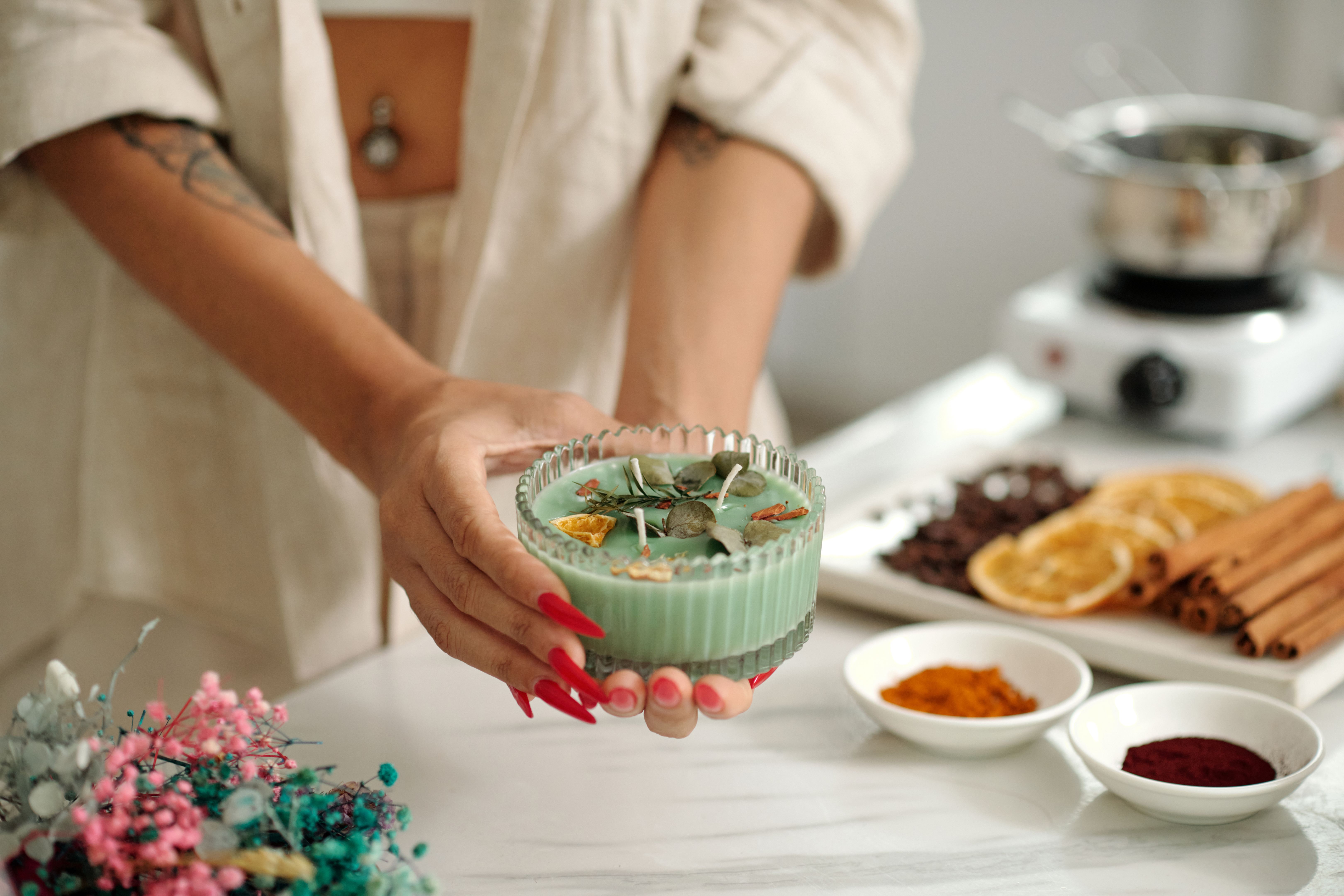 Woman Making Handmade Candle With Aroma Objects