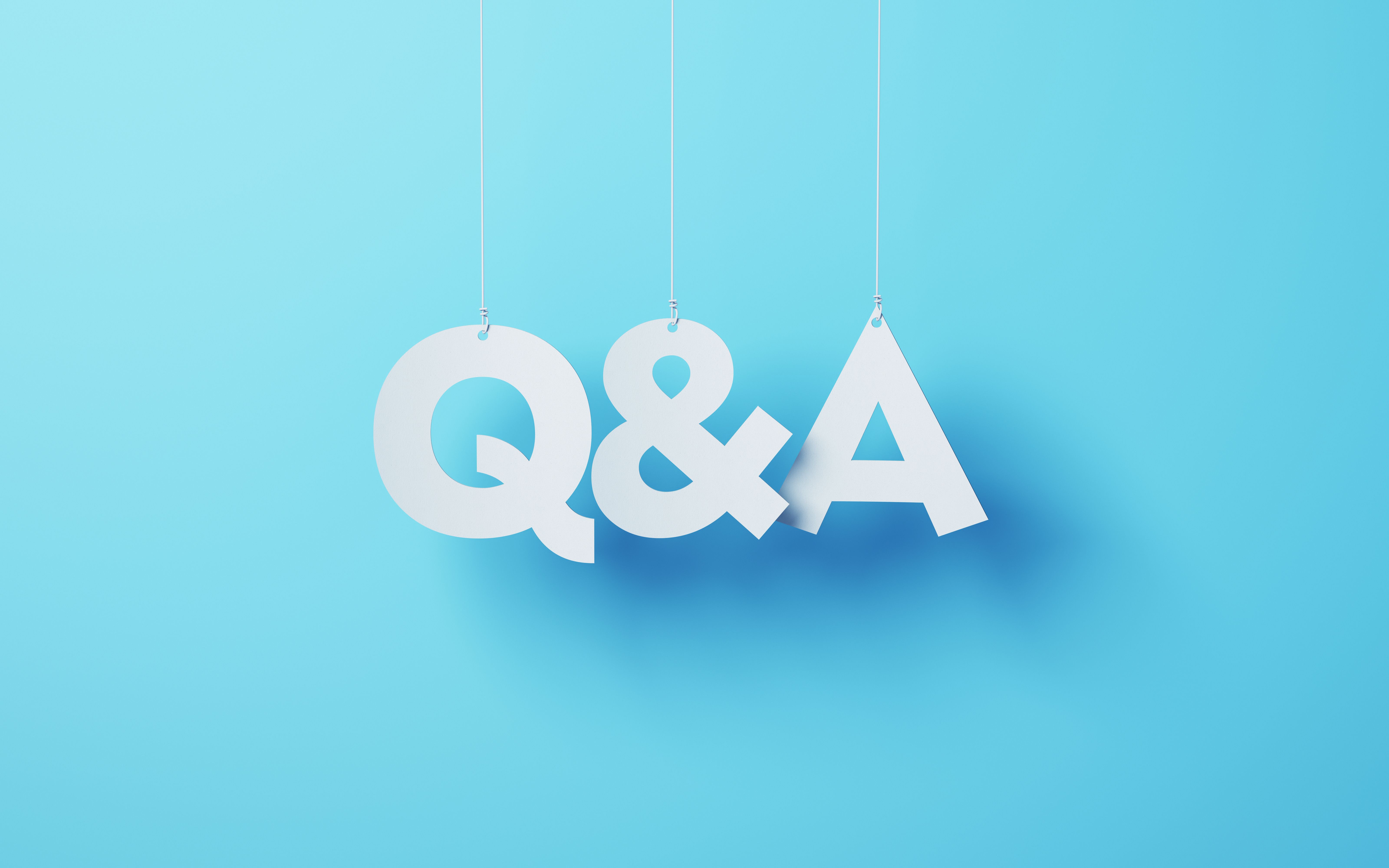 Q&A cut on white note paper hanging on string, White note paper blue background