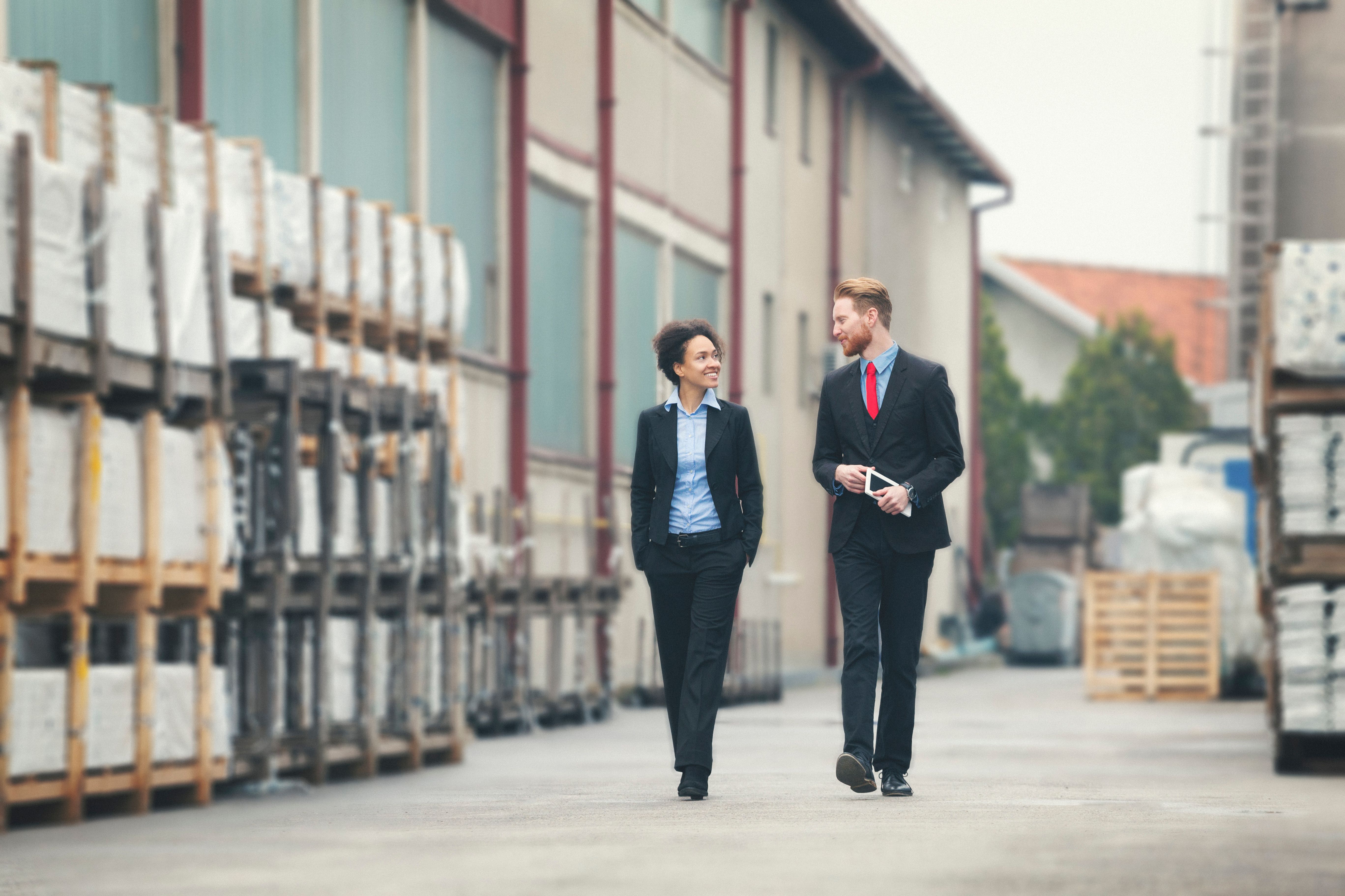 Two businessman walking trough storagehouse