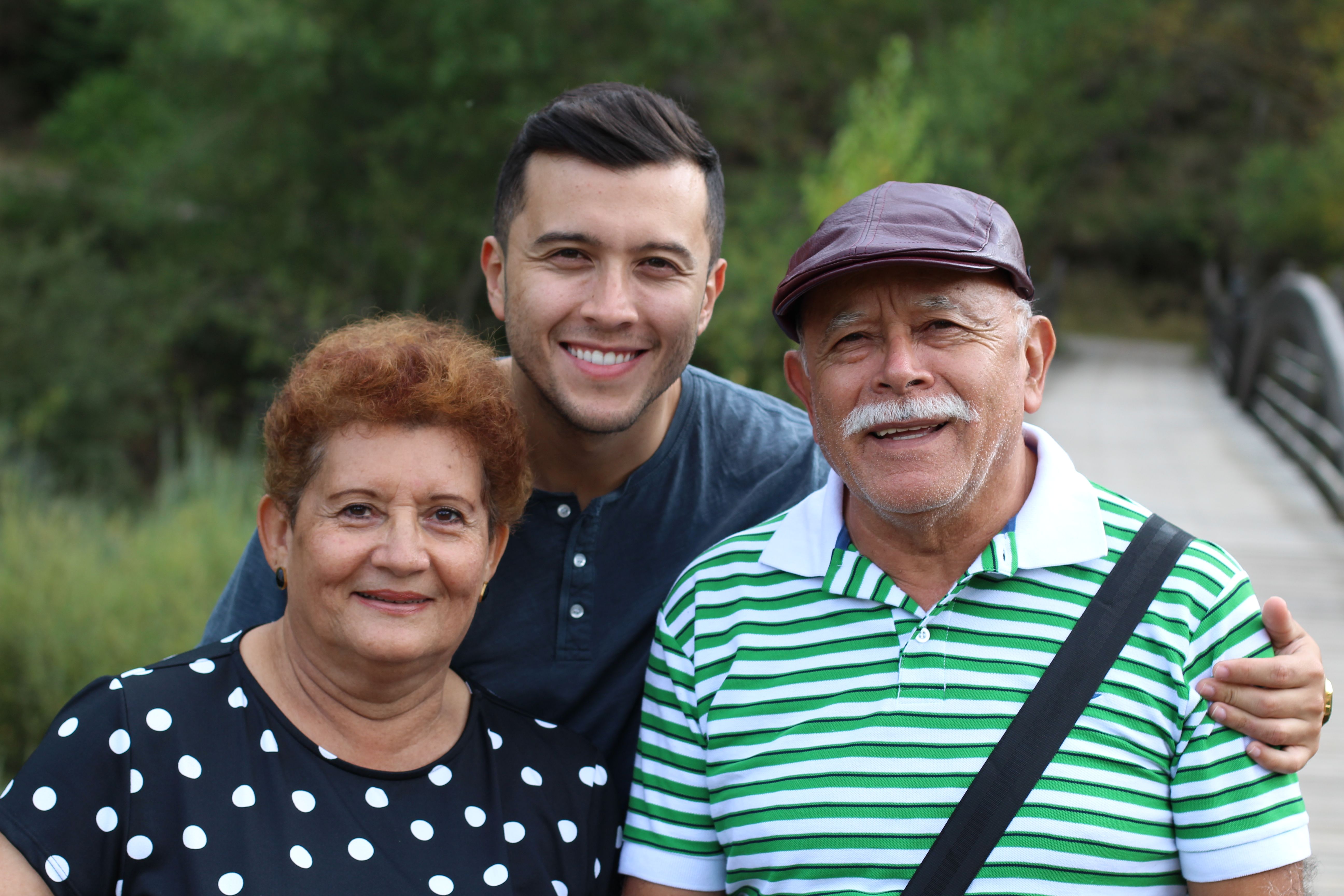 Adult son with his parents outdoors