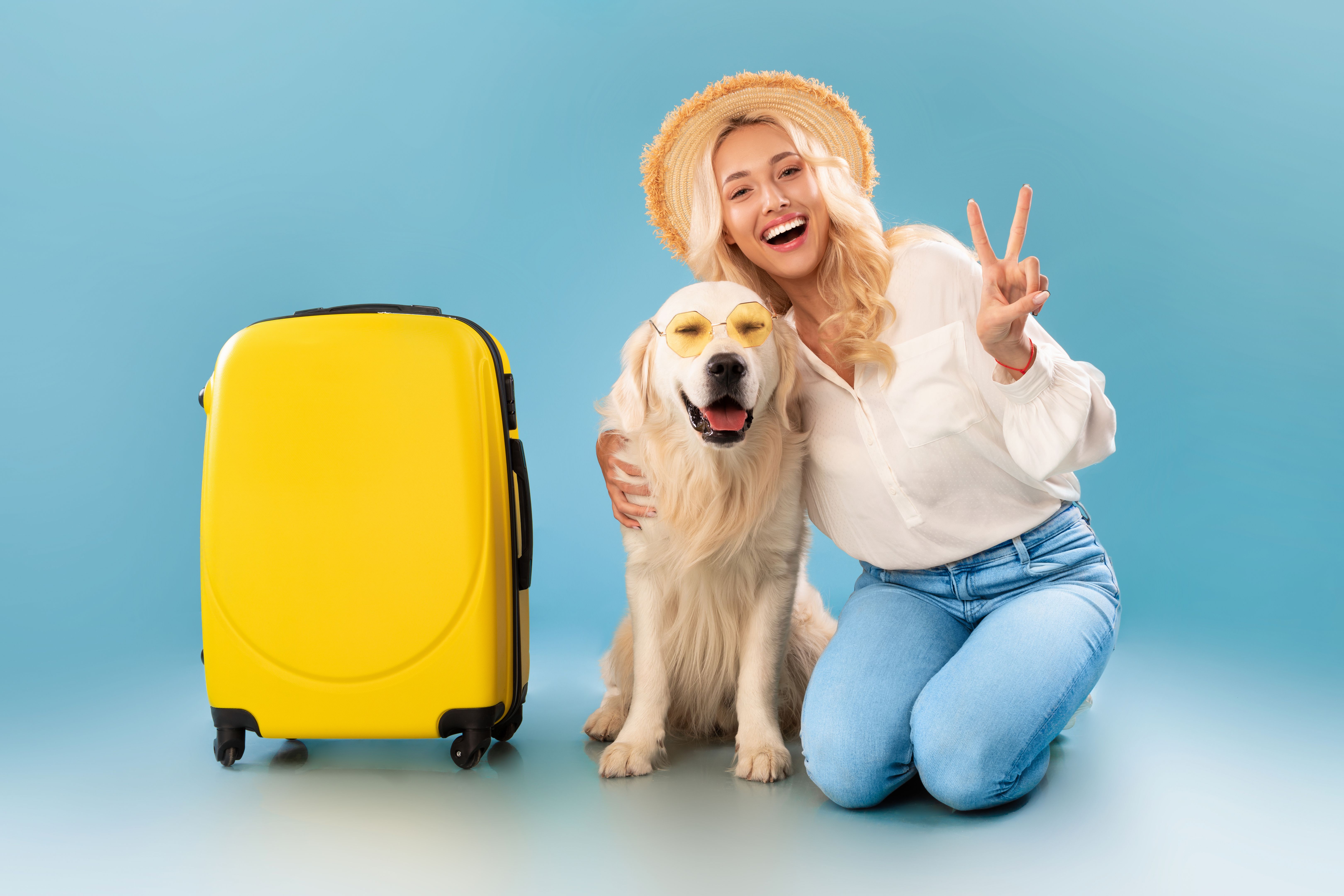 Happy woman posing with dog in sunglasses ready for vacation