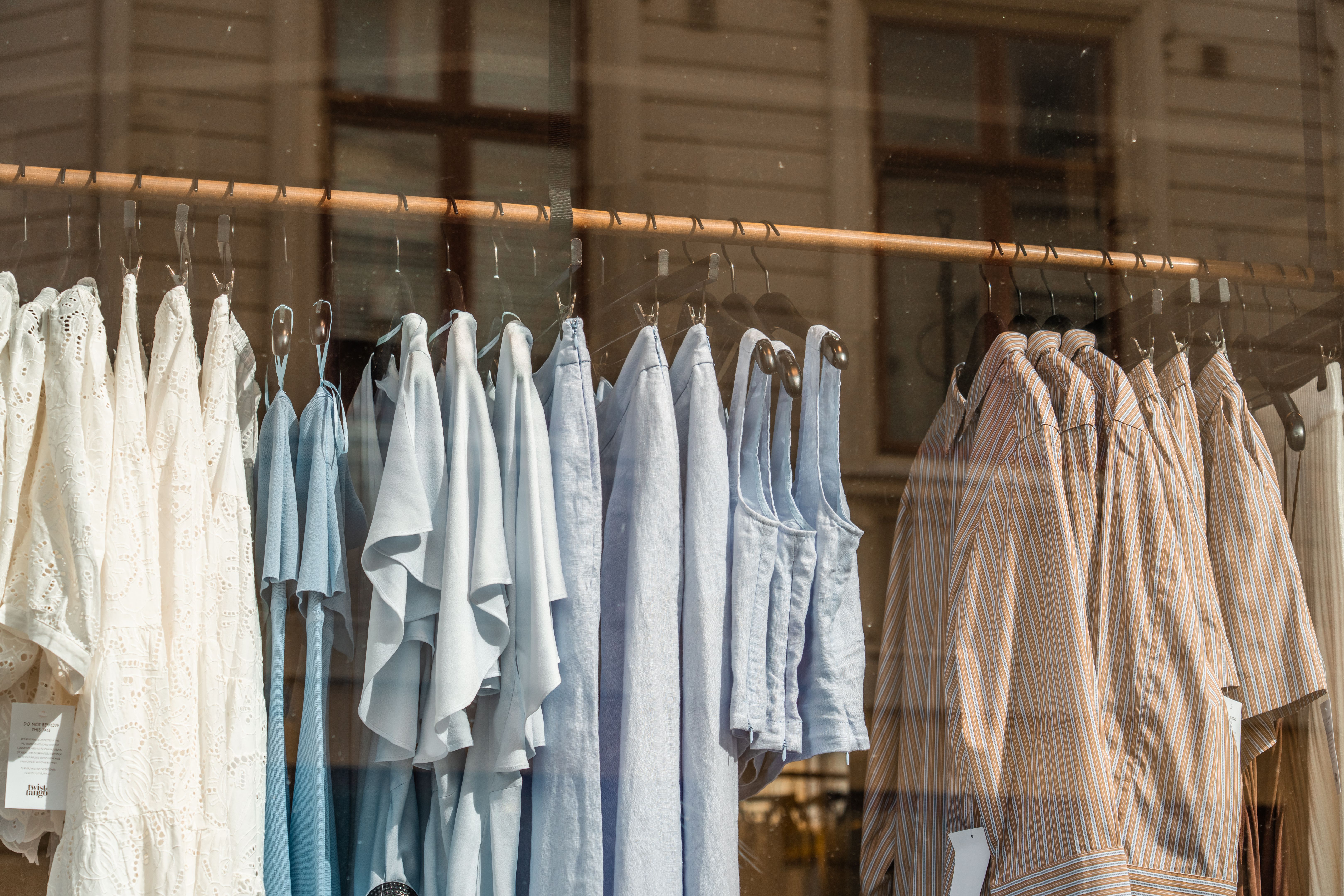 Clothes hanging in a fashion store window in gothenburg, sweden