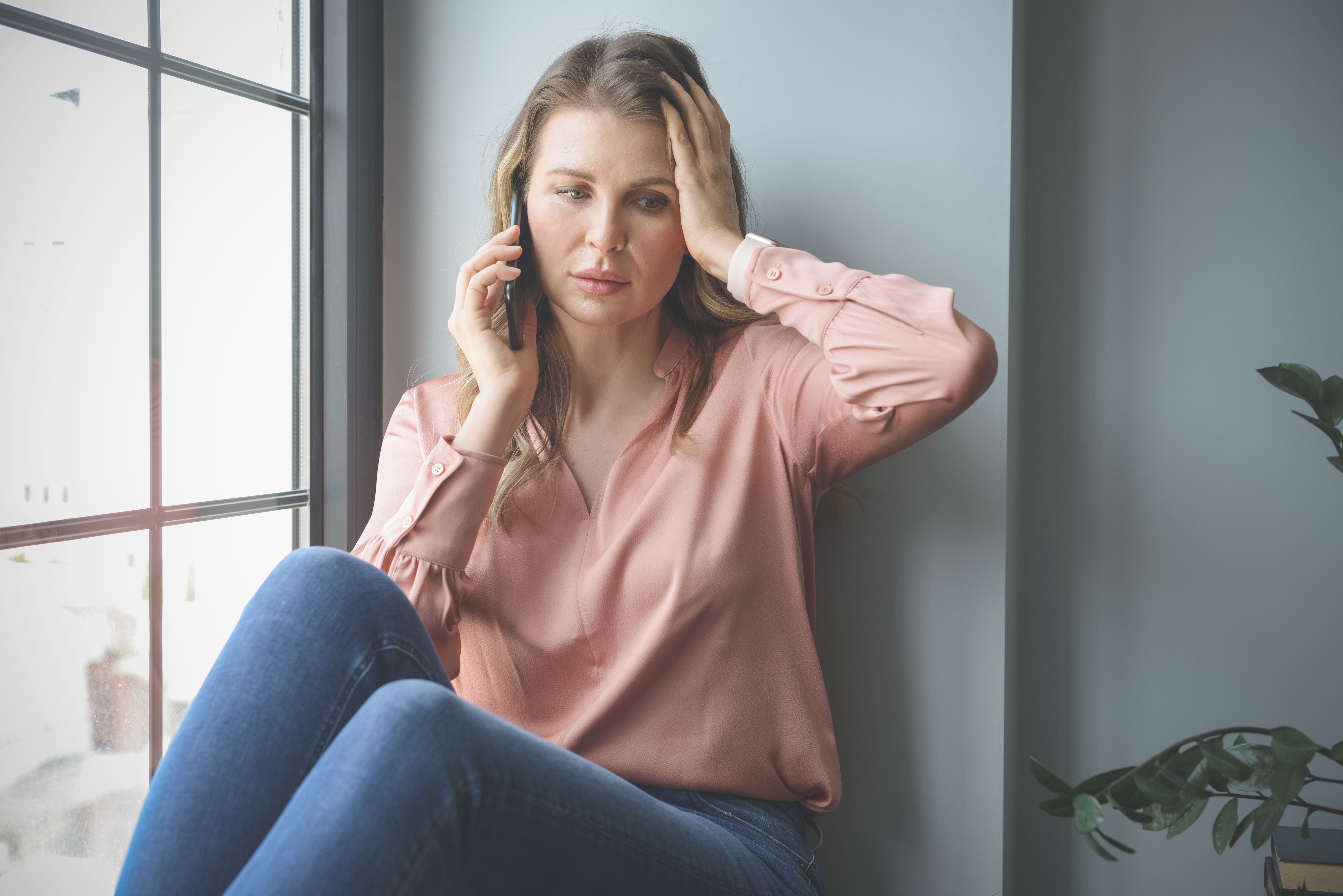 attractive middle aged woman in the office ( negative emotions.mobile phone)