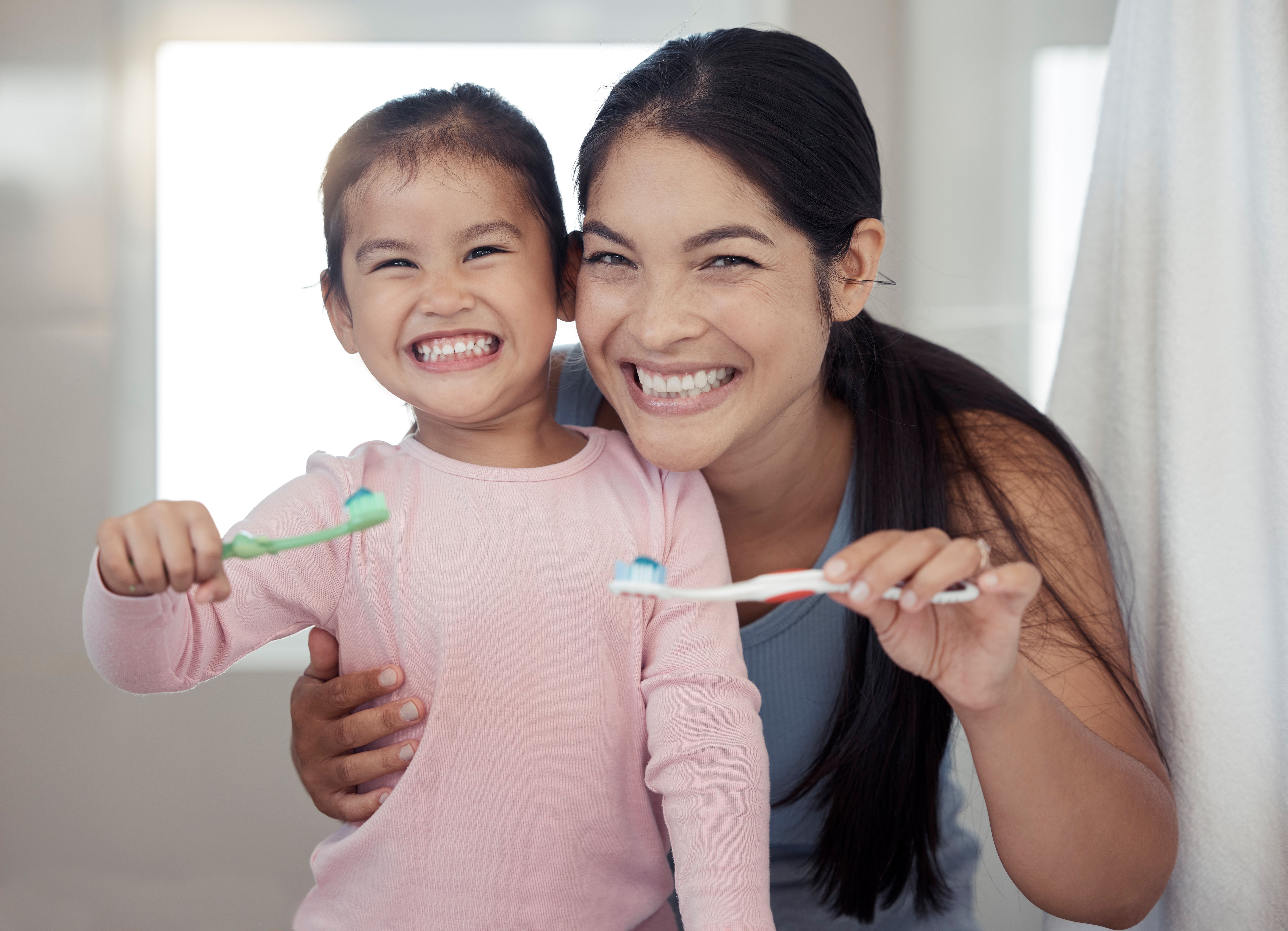family brushing teeth