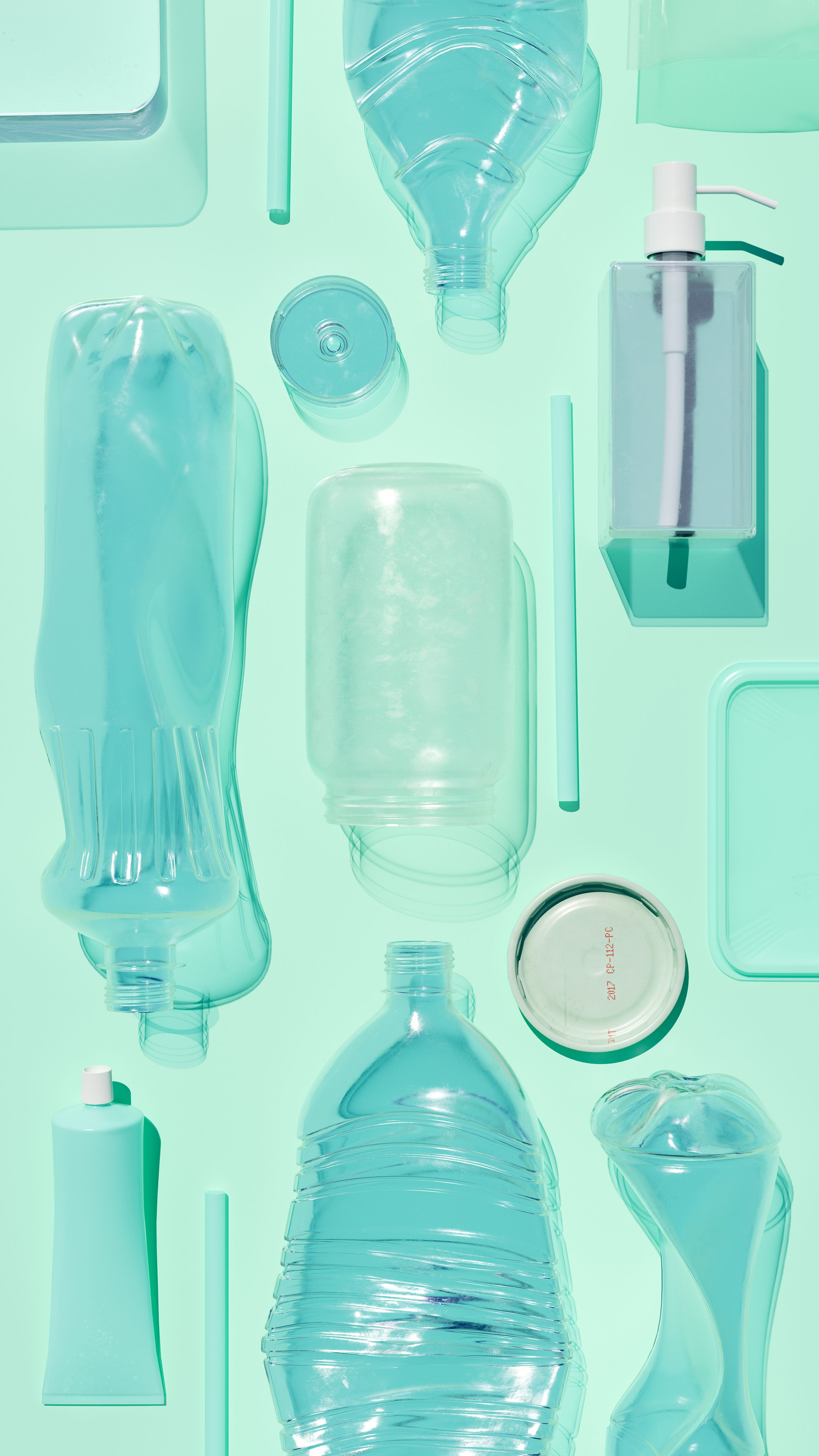 Arranged Plastic Waste on Reflective Turquoise Surface – Waste and Recycling Concept Arranged Plastic Waste on Reflective Turquoise Surface – Waste and Recycling Concept
