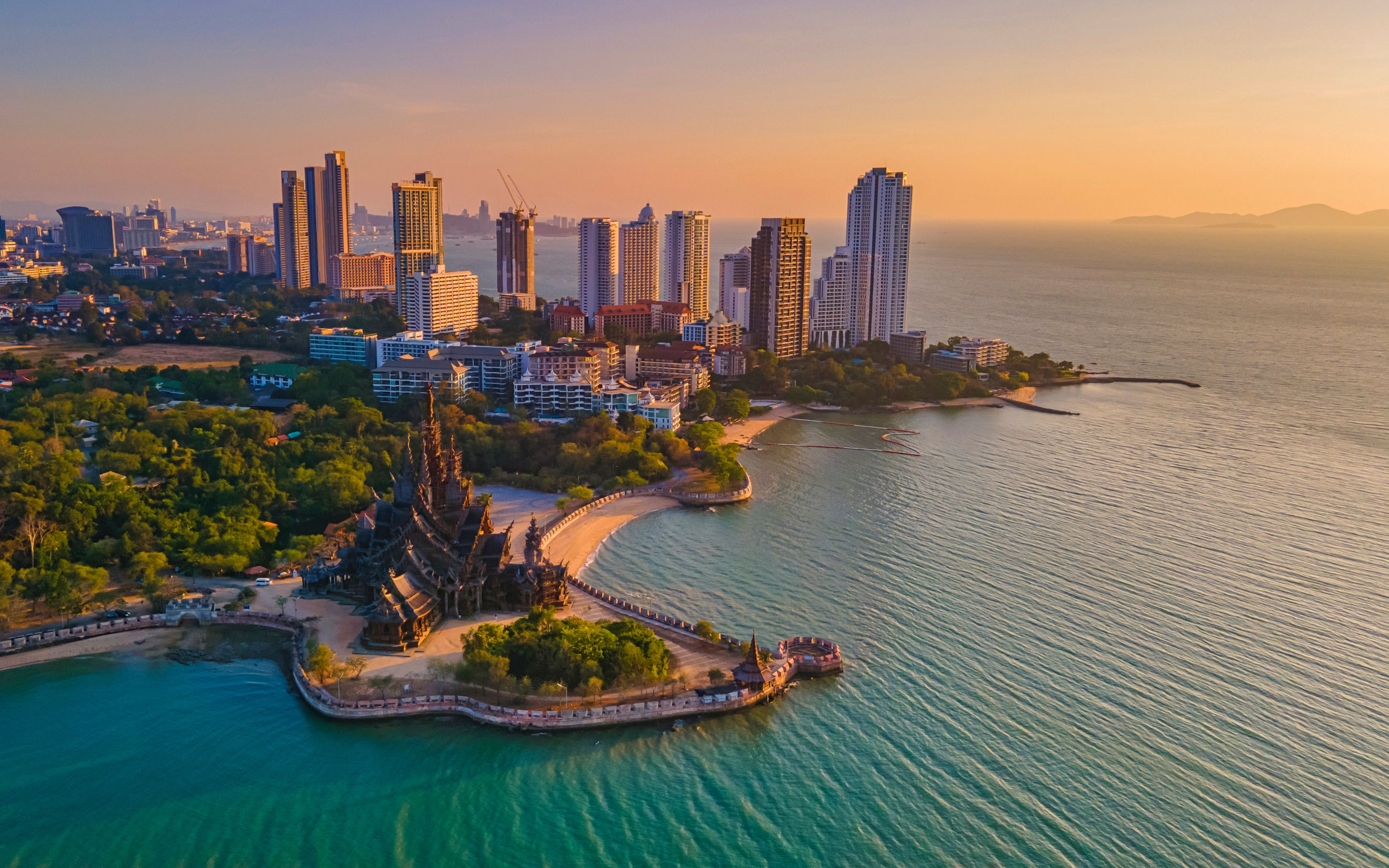 Sanctuary of Truth, Pattaya, Thailand, wooden temple by the ocean at sunset on the beach of Pattaya