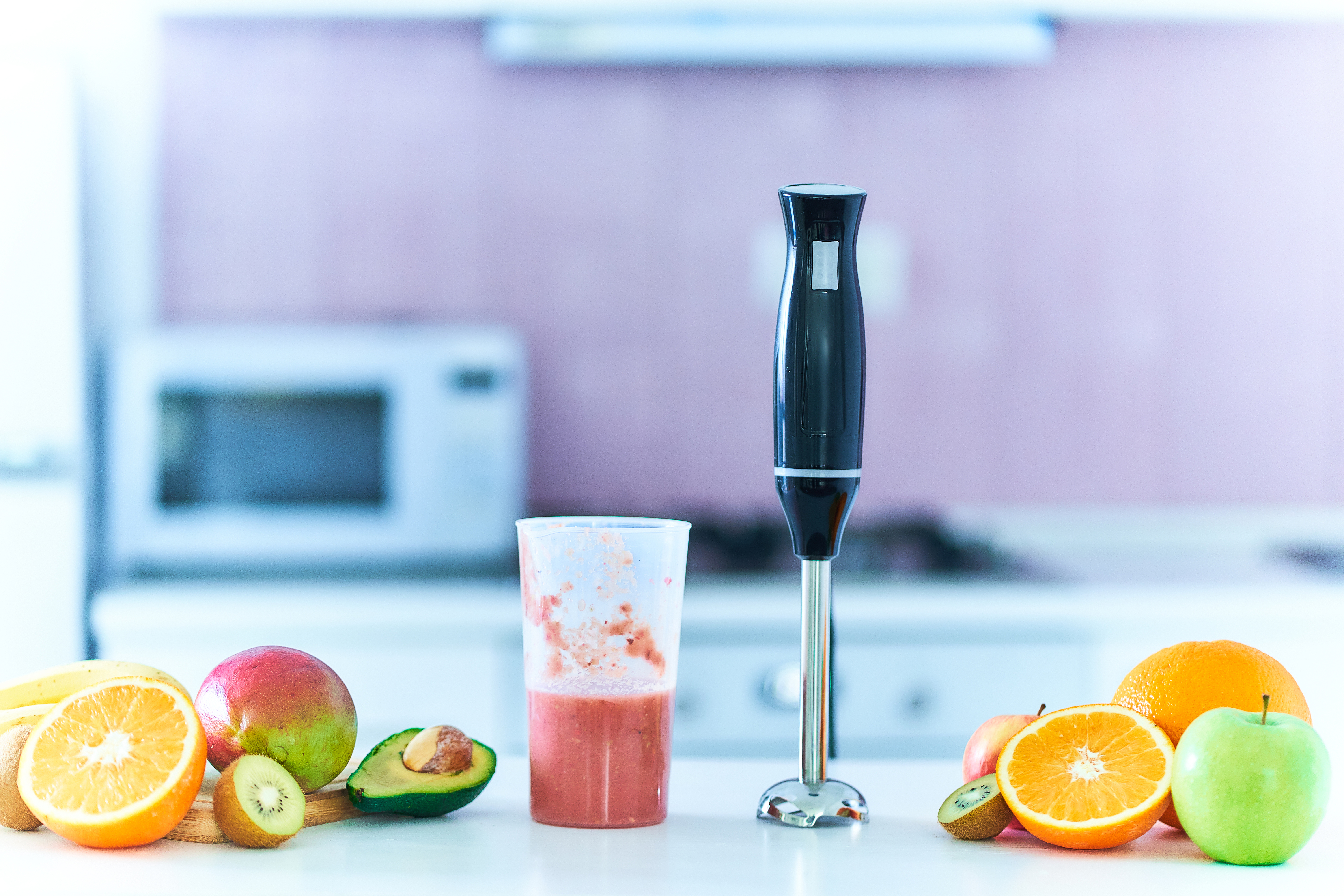 Hand blender for mixing organic raw fresh fruits for prepare vitamin diet smoothie for losing weight and healthy eating