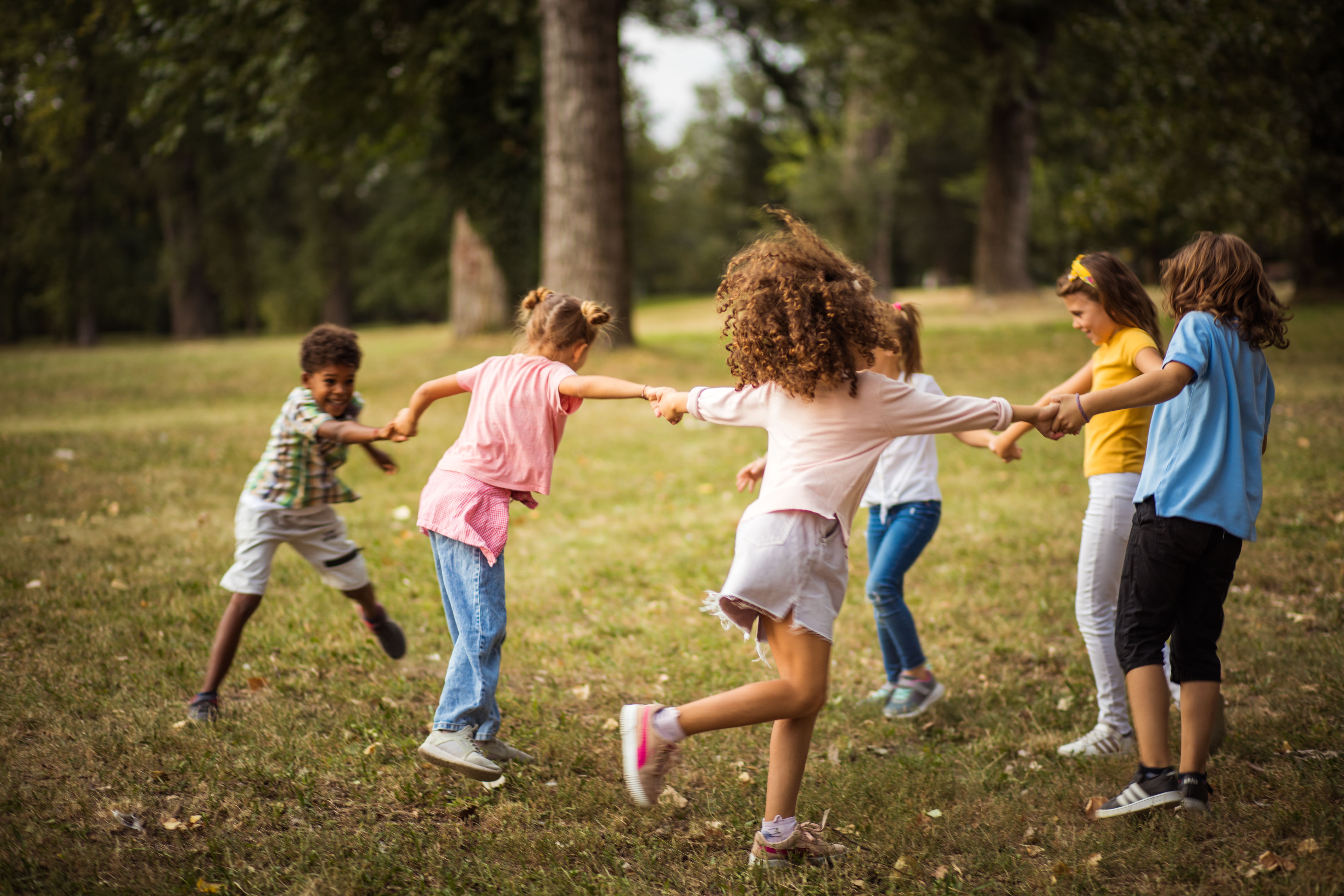 Large group of school kids having fun in nature.