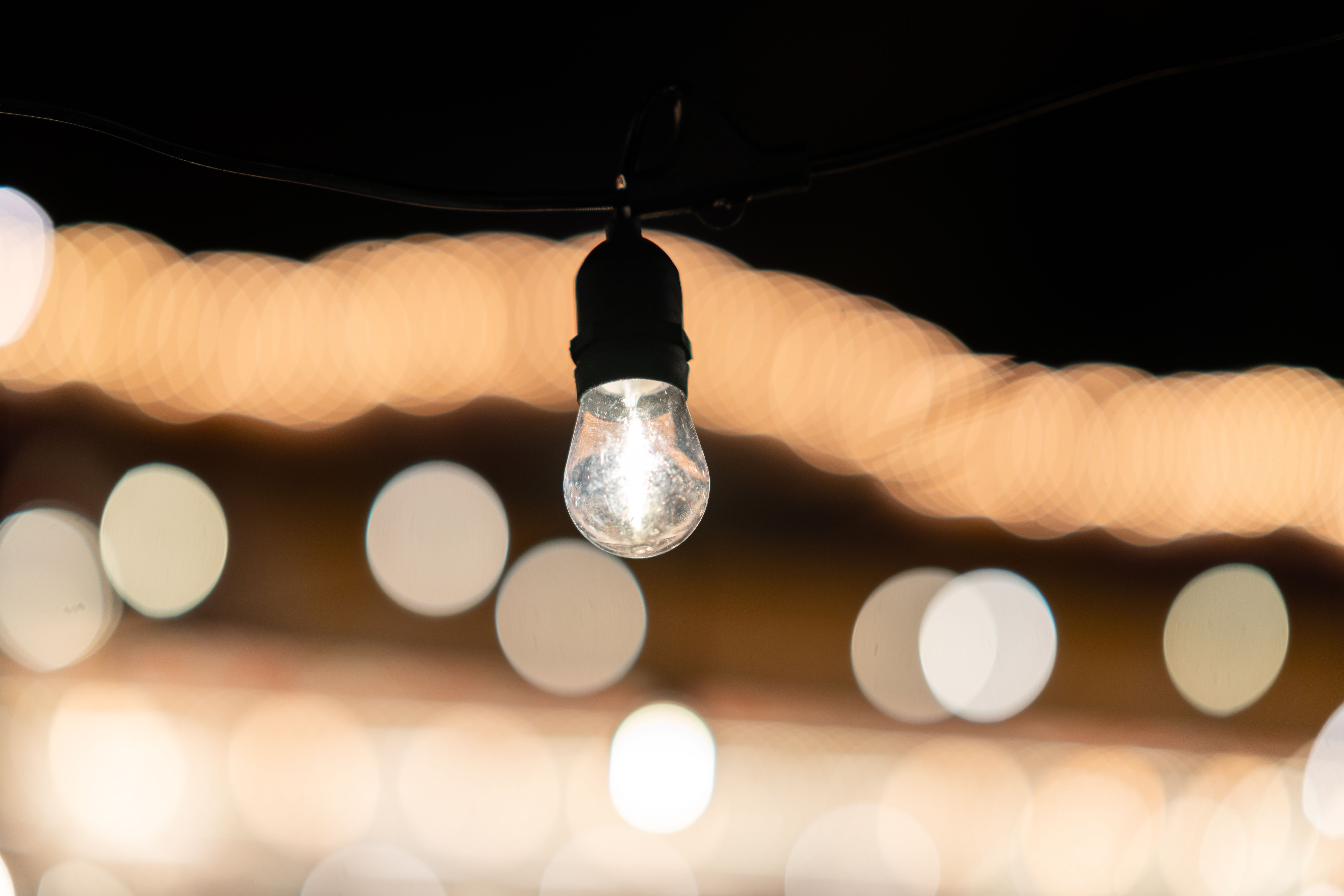 Single light bulb hanging, creating a warm and inviting ambiance in the dark