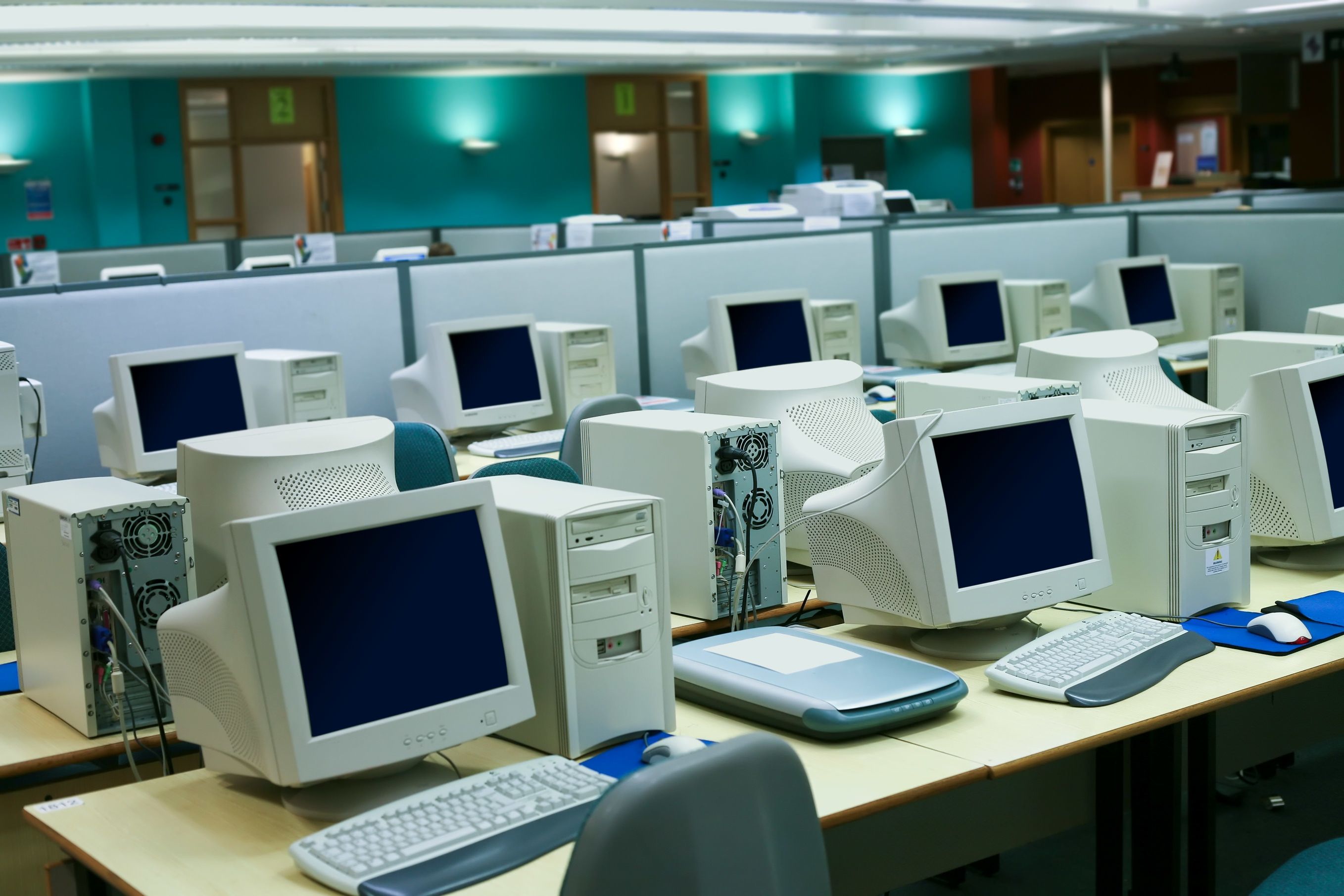 Wide angle shot of a business environment with a myriad of old computers in the room