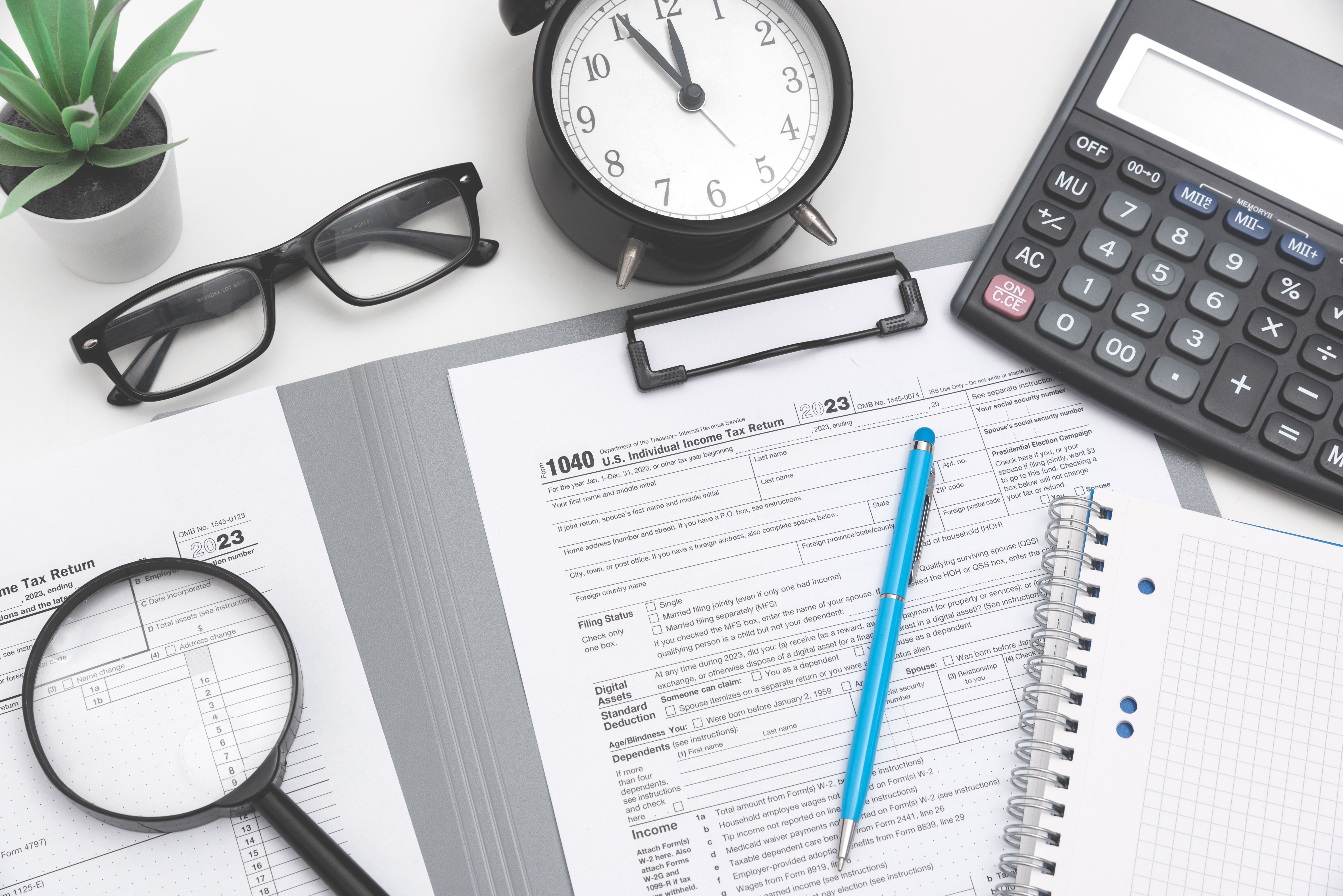 Tax income concept with calculator and pen on desk