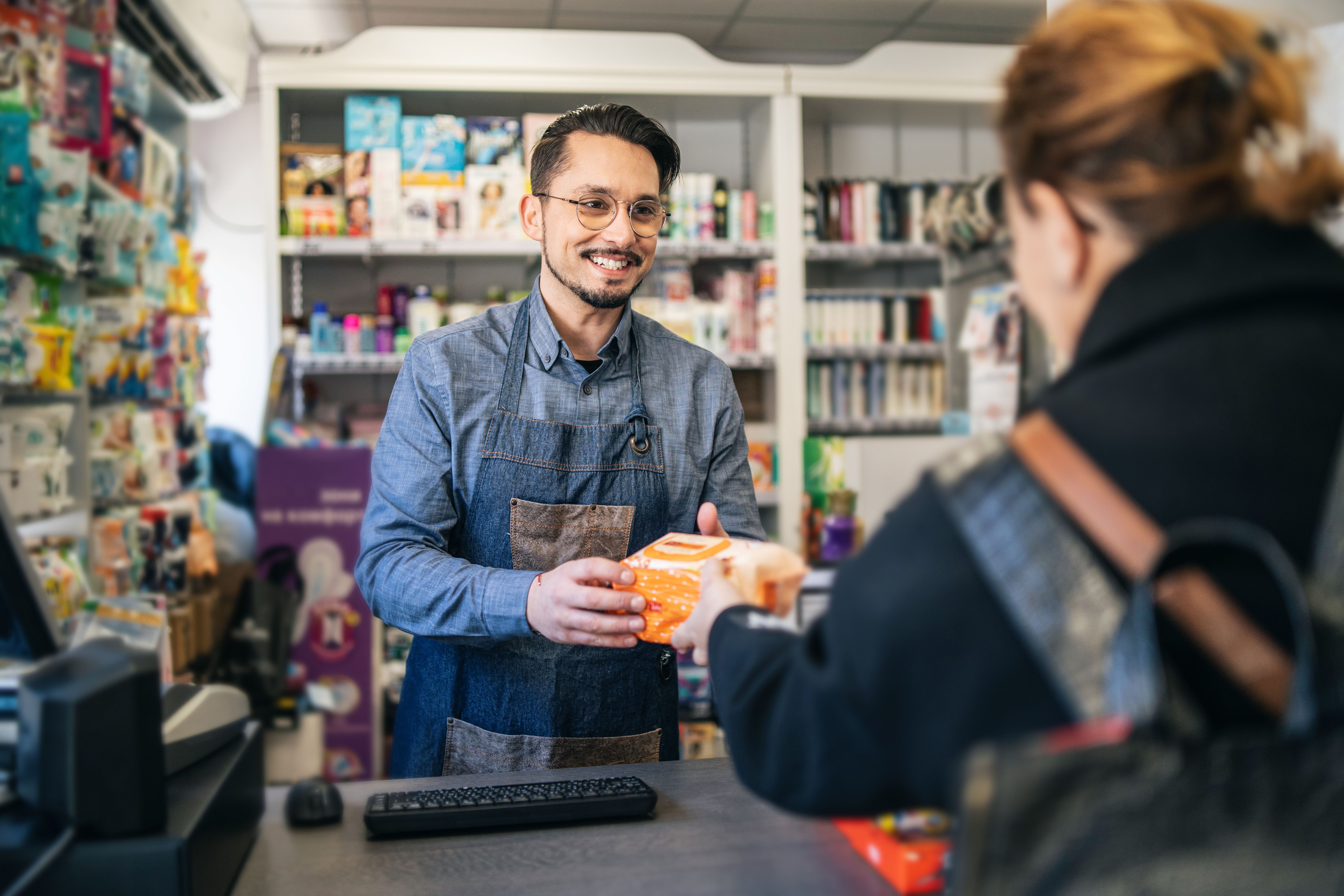 Successful owner at the supermarket registering products