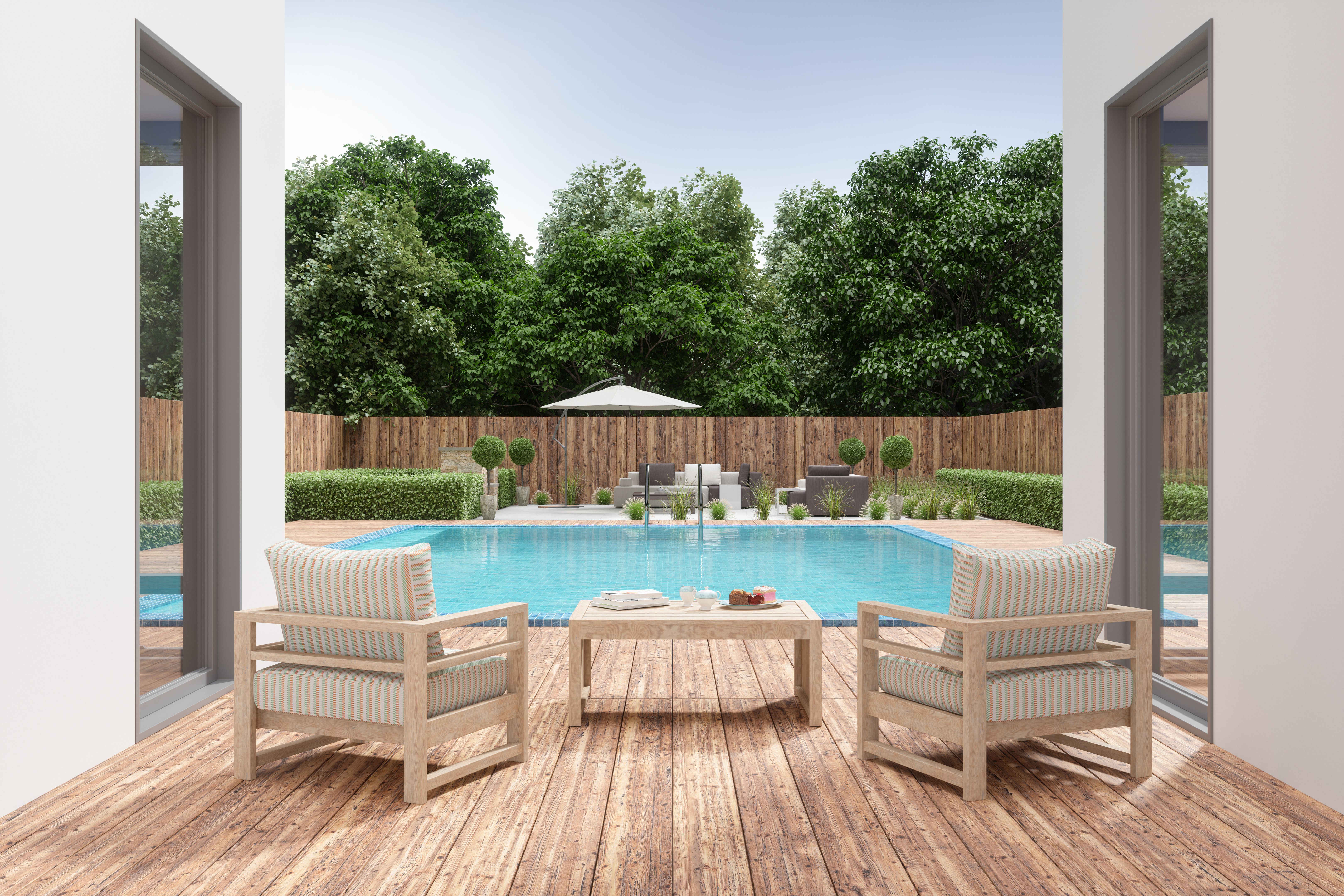 Villa Patio With Armchairs And Coffee Table By Swimming Pool